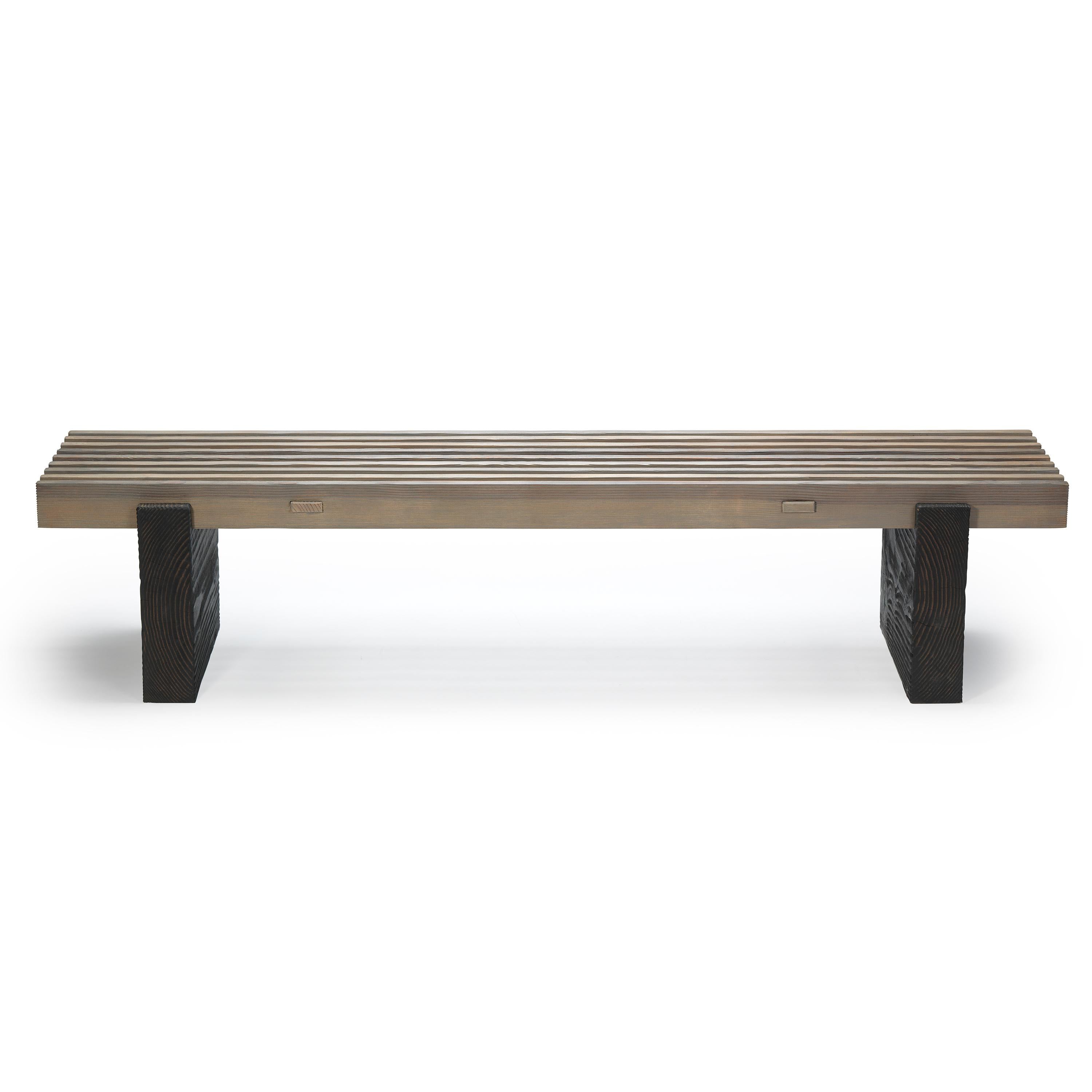 Ten10 Slat Bench made with vertical grain Douglas fir. It is suitable for indoor or outdoor use. The style of this bench is rustic. The legs are darker than the seat slats for subtle contrast. Custom sizes available - lengths up to 8' long. This