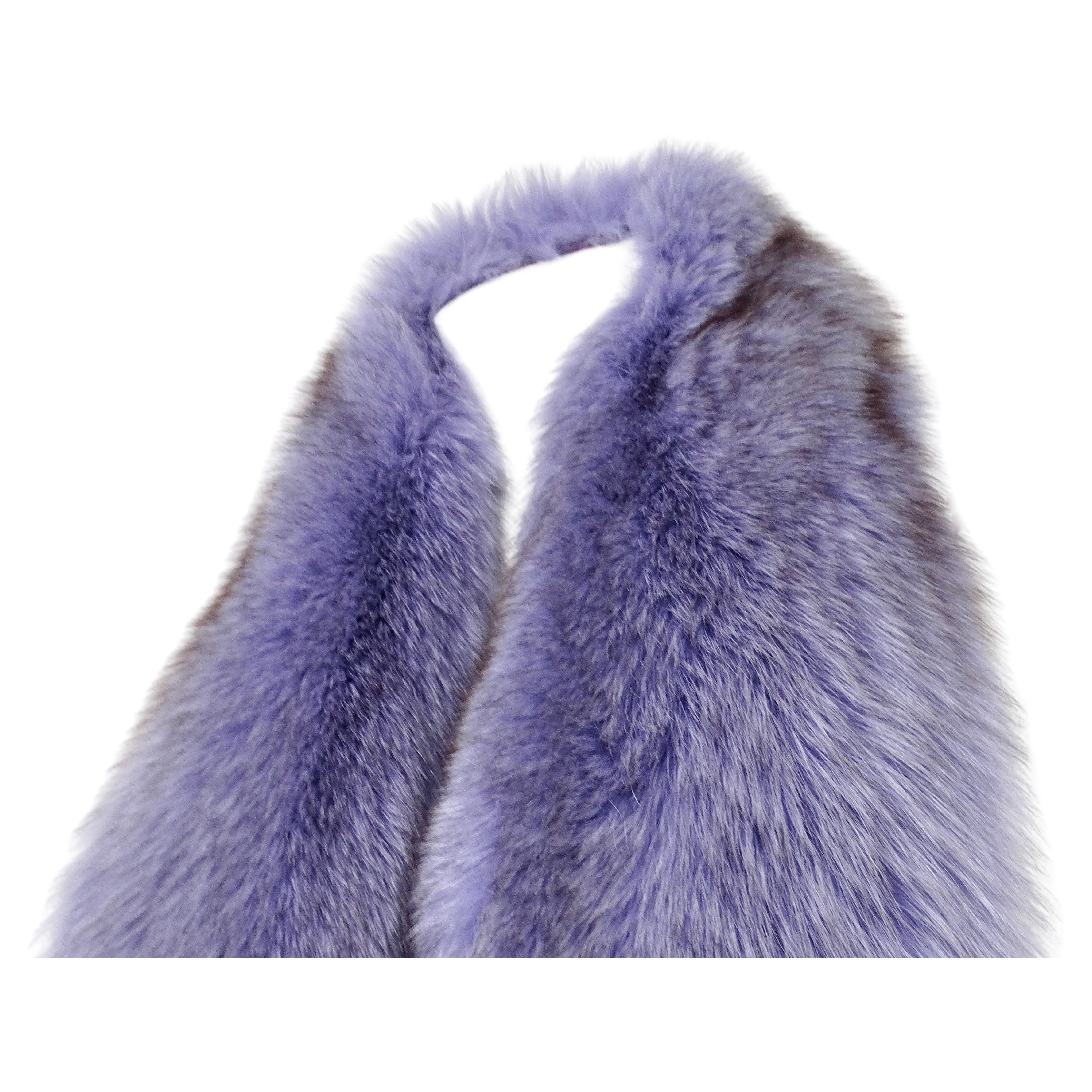 The Douglas Hannant Purple Fox Fur & Silk Scarf from the circa Y2K era is a luxurious and sophisticated accessory that exudes elegance and opulence. Crafted from plush purple fox fur, this scarf provides a rich, tactile experience, offering warmth