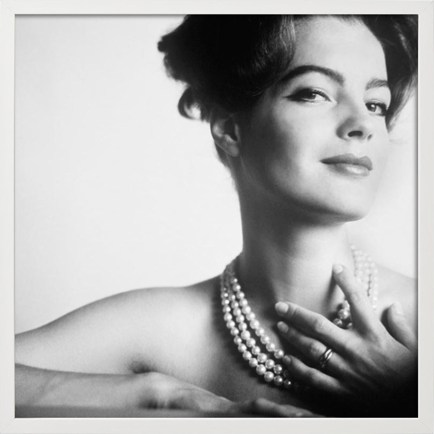 Portrait of romy schneider, almost naked only with a pearl necklace touching her - Gray Black and White Photograph by Douglas Kirkland
