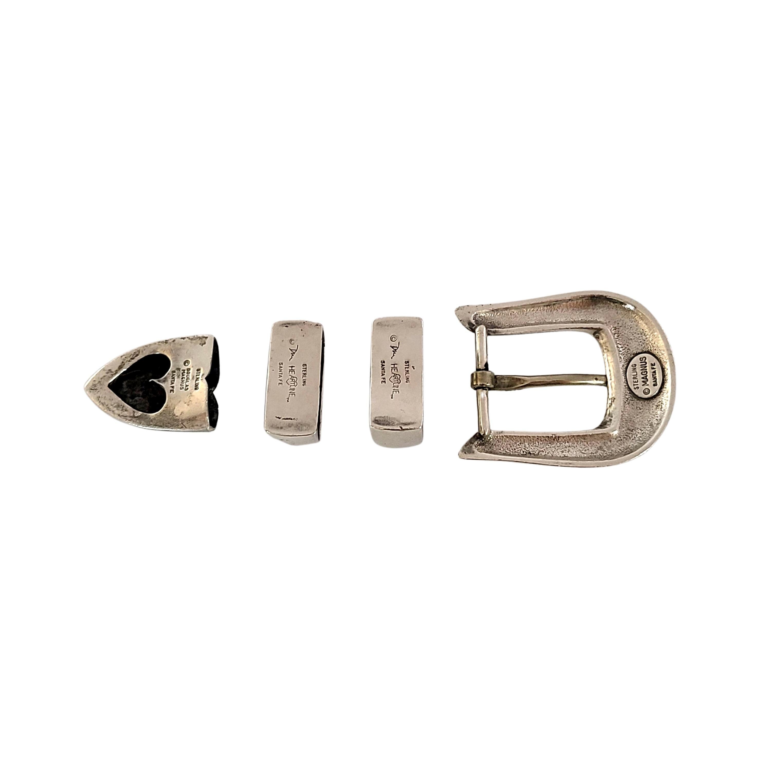 Vintage sterling silver 4pc set: belt buckle, 2 keepers and tip set by Douglas Magnus Santa Fe.

This belt set includes a buckle, 2 keepers and tip with a polished smooth design. The back of the tip has a heart shaped cut-out design.

Buckle