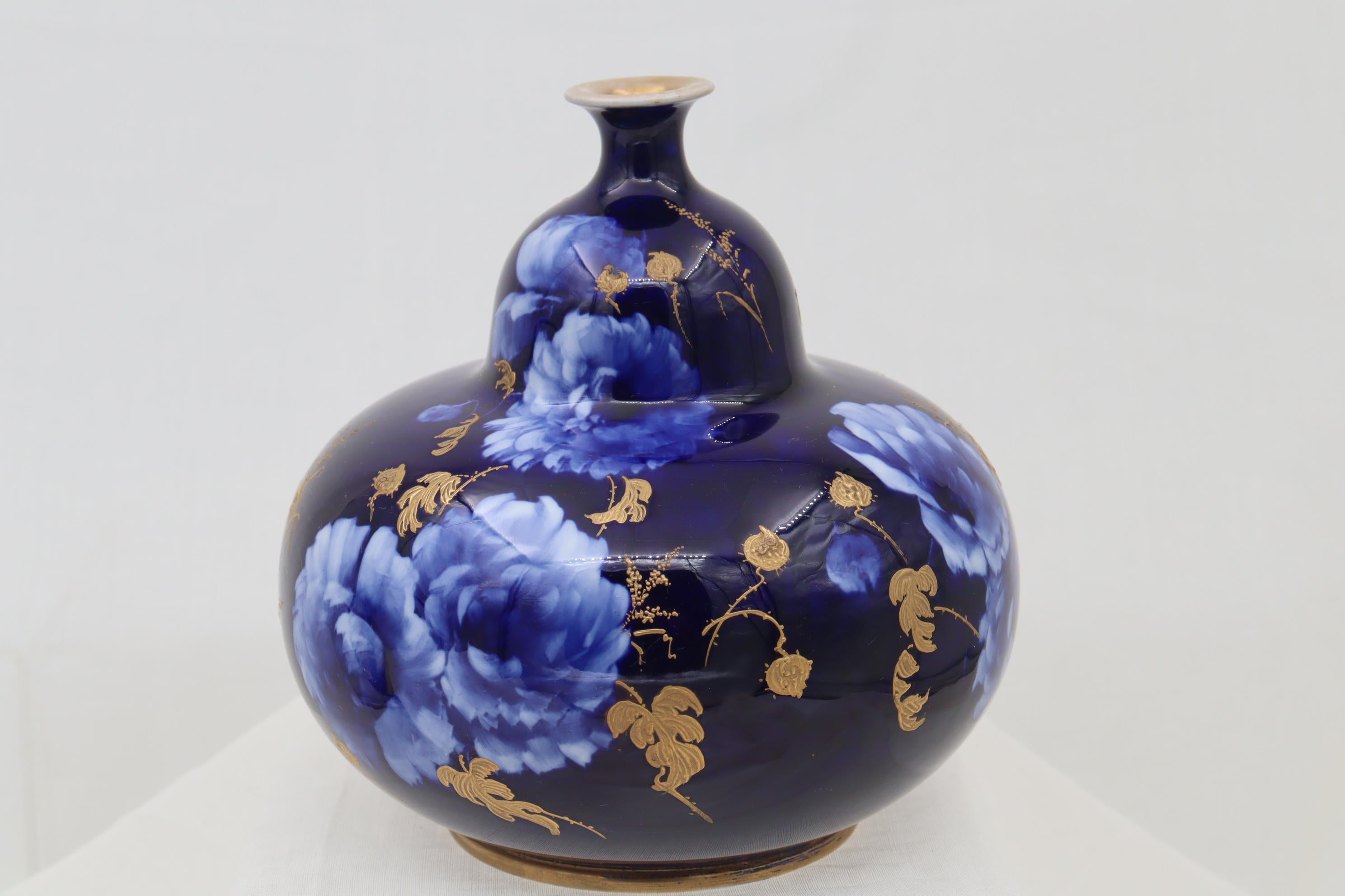This gourd shaped vase is from Doulton Burslem's Corolian Ware line that was made from 1891-1902 and came from the studio of Robert Allen, a very talented designer and painter. The decoration was achieved using the sgraffito method, where the vase