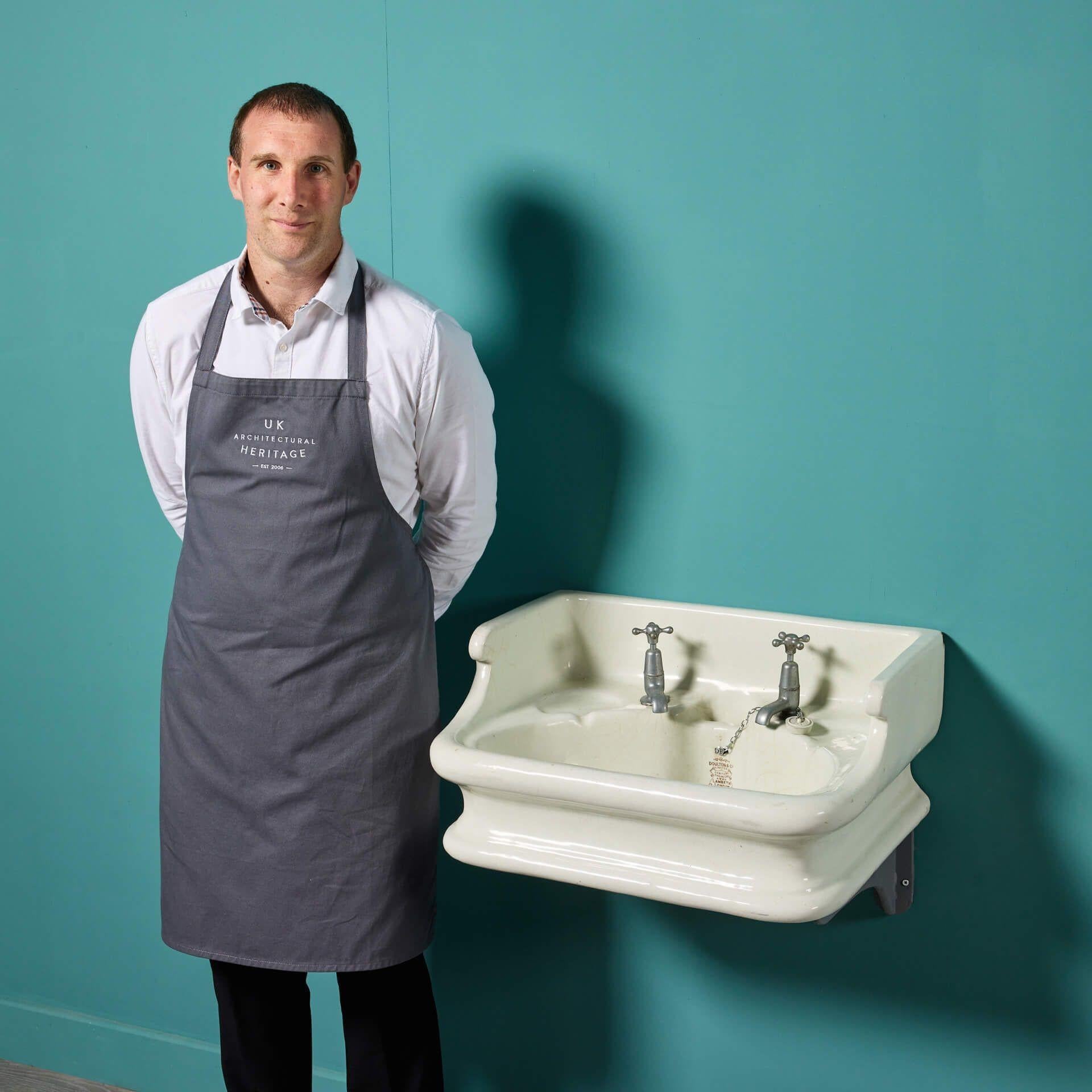 A 19th century Doulton and Co. stoneware sink. Dating back to circa 1890, this stylish piece is smoothly curved, accompanied with an integrated splash back. Its unusual shape would make for a new stylish piece in the bathroom of a contemporary or