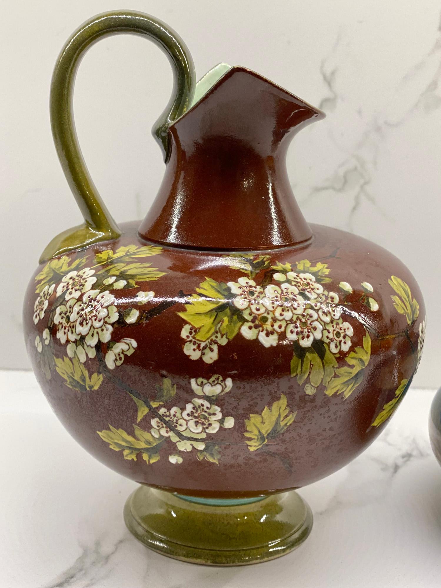 Doulton Faience hand painted floral decorated vase by John Eyre and dating from around 1885. Mdina squat rounded art glass vase by Michael Harris dating from the 1970's.