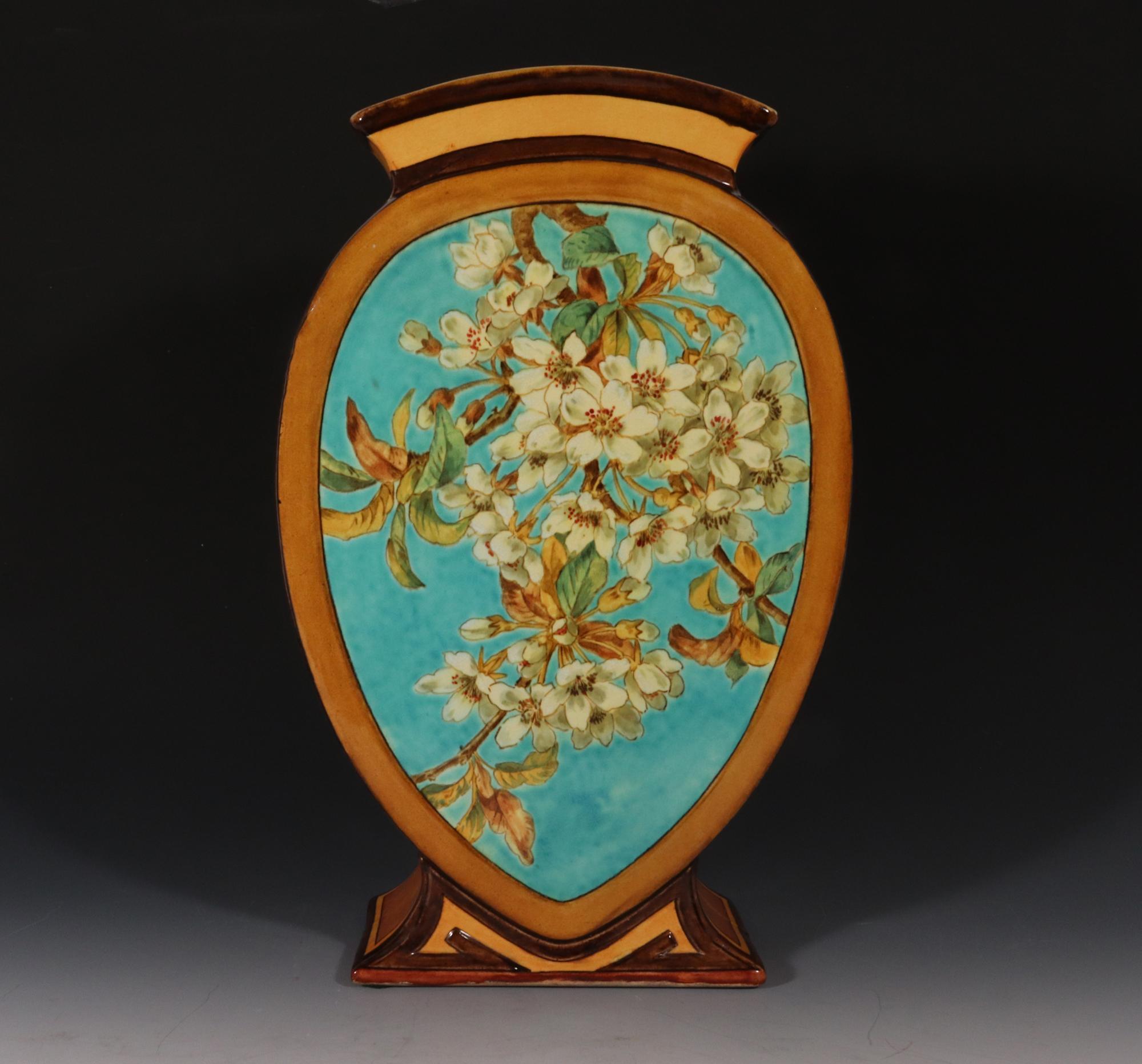 Doulton Faience Shaped Botanical Pottery Vase,
Aesthetic Movement,
Signed by Artist Mary M Arding,
Early 1880s

The unusually shaped molded vase with a flared foot has a reverse pear shape with a similarly shaped aqua-colored panels with