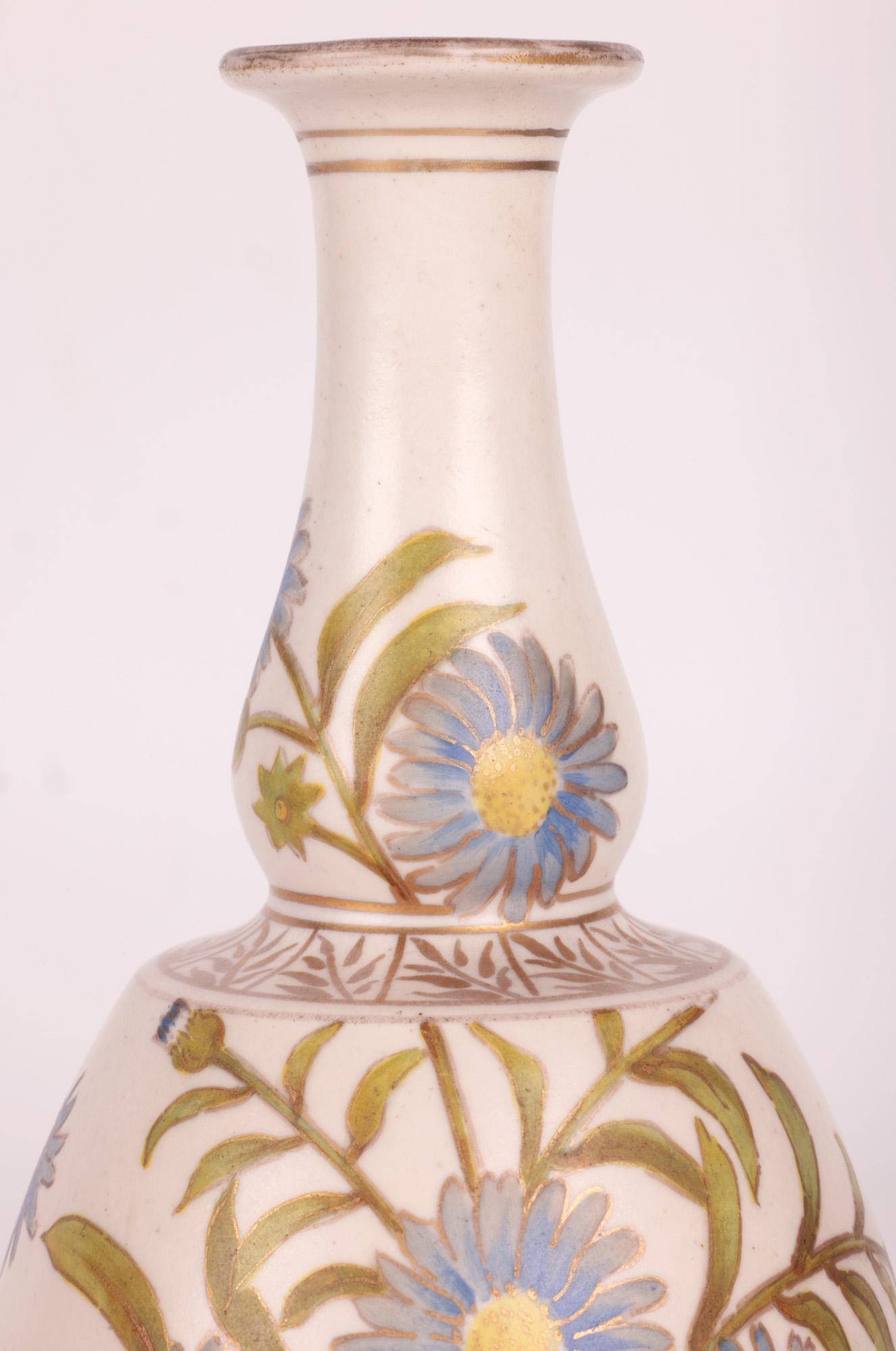 A stylish and impressive Doulton Lambeth Carrara floral painted art pottery vase signed AB and dating between 1887 and 1891. The vase stands on a narrow round foot with slightly recessed base with a round bulbous lower shouldered body with a narrow