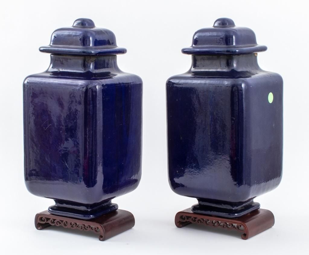 Pair of Doulton Lambeth British Aesthetic Movement cobalt-glazed faience ceramic square-form covered baluster jars, circa 1876-1880, with domed lids and high shoulders, the vases resting on scrolling reticulated bases, in the Chinese taste, all