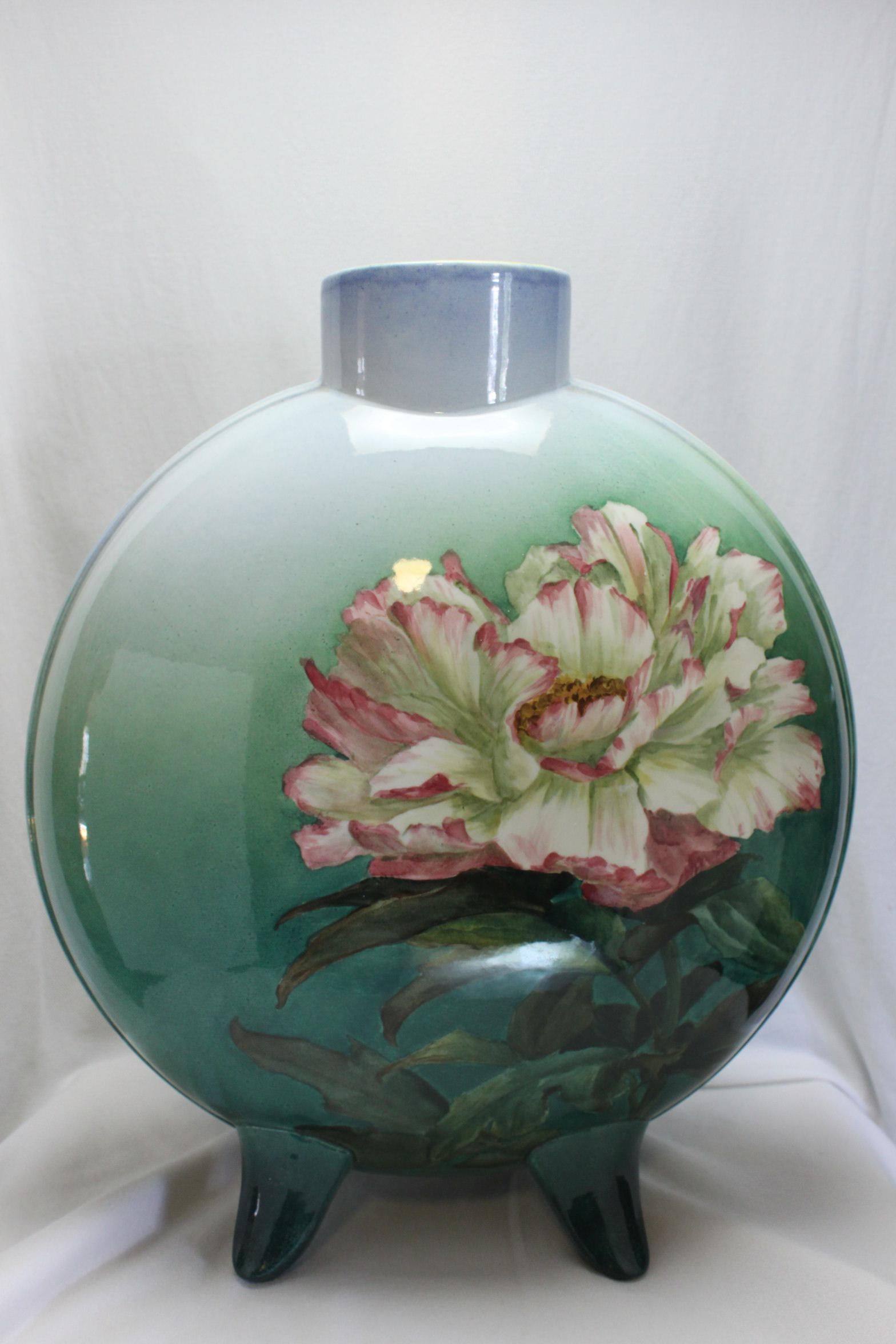 This very large Doulton Lambeth Faience flask vase was painted by Katherine (Katie) Smallfield, who worked at Doulton from c1882-1912. Both sides of the vase are decorated with a single large flower on a graduated green ground. It stands 360 mm