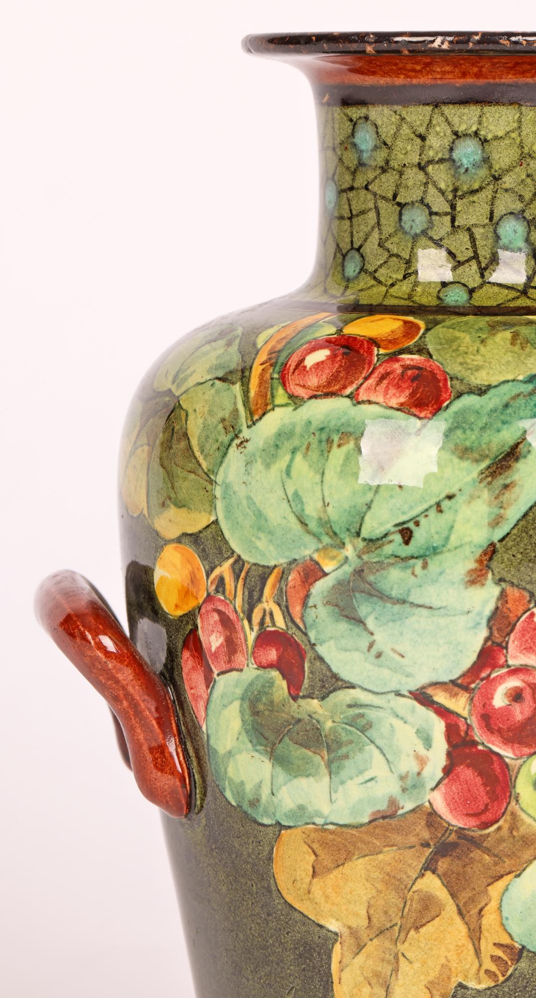A very stylish Doulton Lambeth Faience Aesthetic Movement twin handled art pottery vase hand painted with floral designs by renowned artist Mary M Arding and dating from around 1884. The vase of tall bulbous shape with a tapered round body narrowing