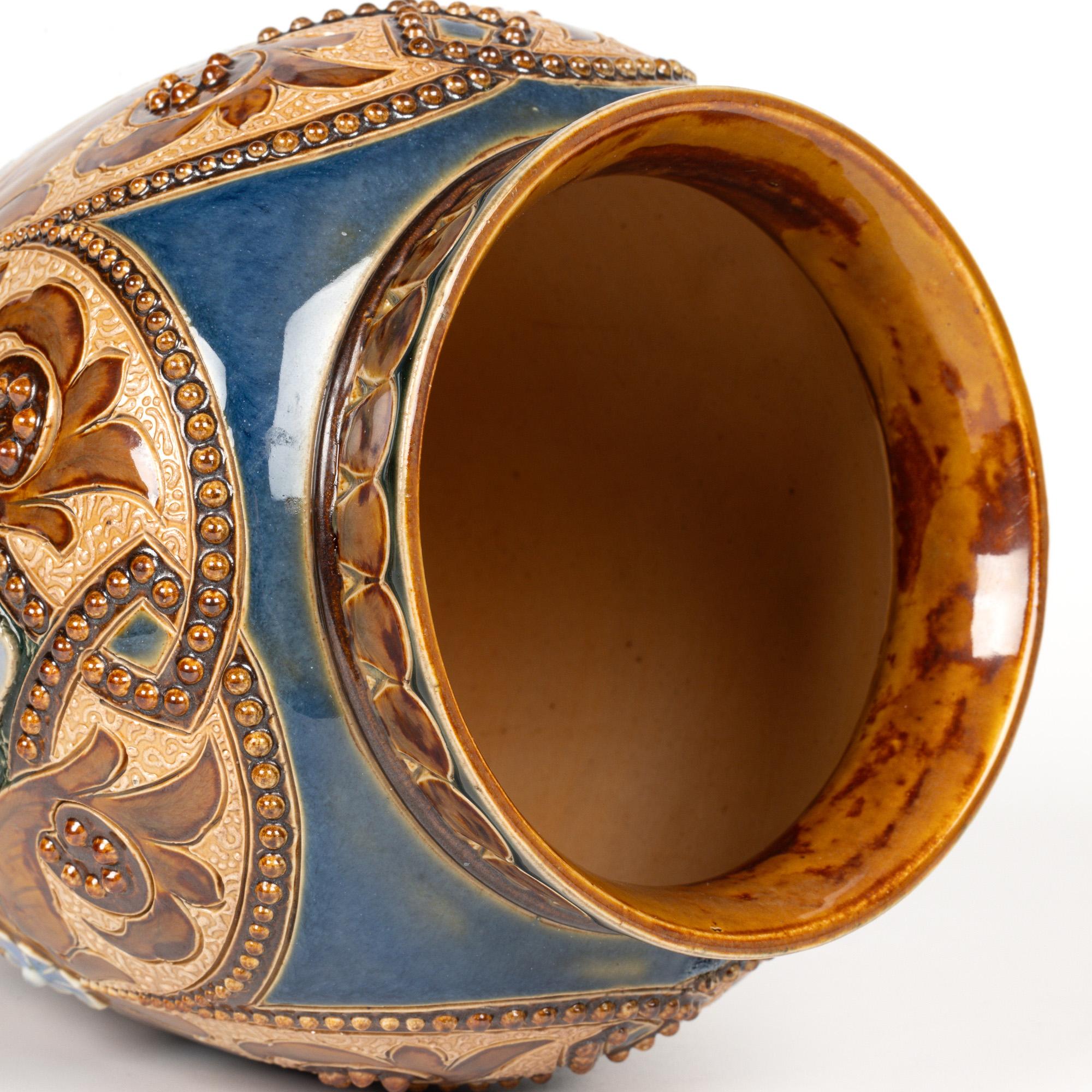 A stunning transitioning Aesthetic Movement/Art Nouveau Doulton Lambeth art pottery floral and scroll design vase by renowned artists Eliza Simmance and Emily Stormer and dating from around 1892.  The elegantly shaped stoneware vase stands raised on