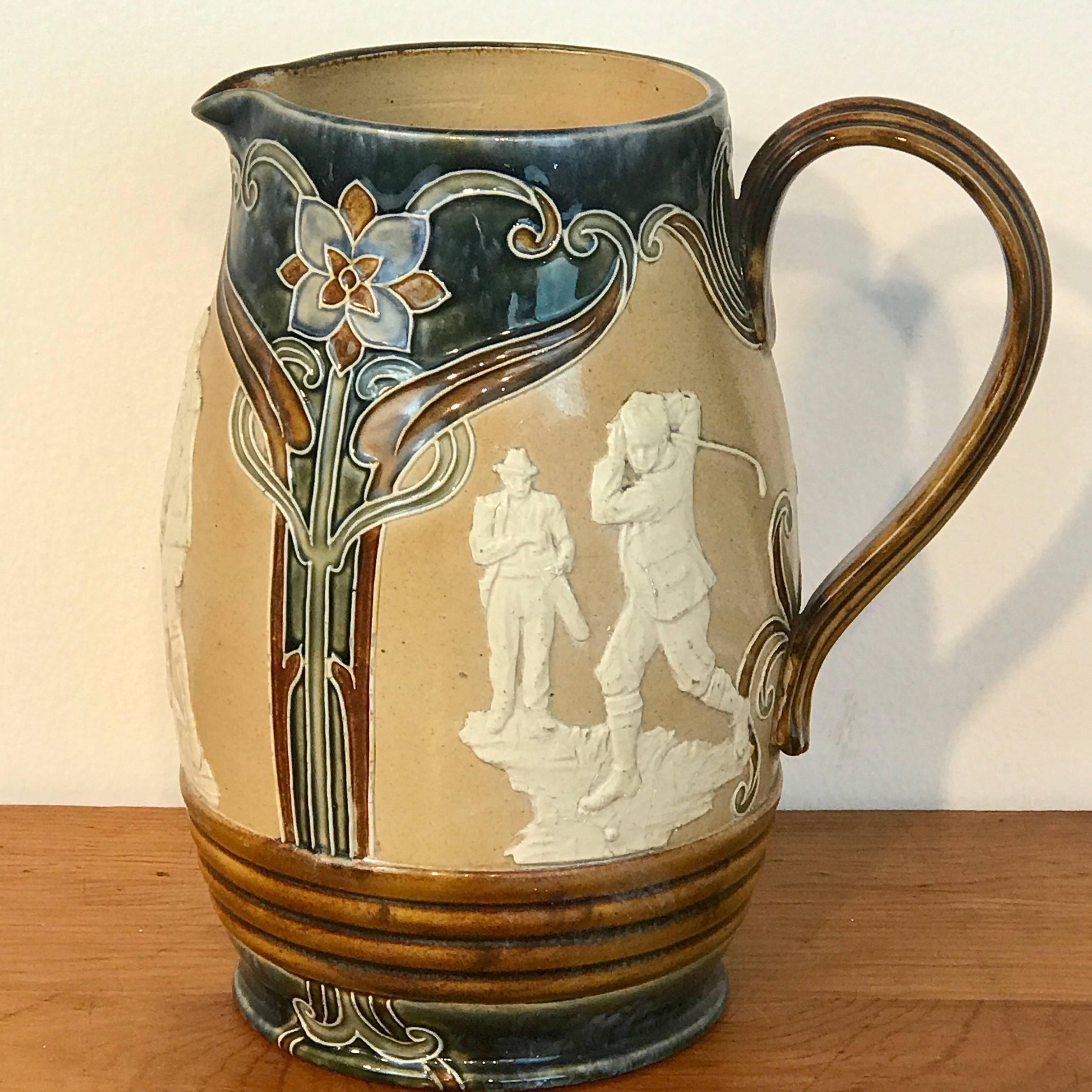A Royal Doulton Lambeth Art Nouveau stoneware jug with three golf vignettes, Stamped 'Doulton Lambeth England #166 and incised initials 'P'B. The pitcher stands 9.5