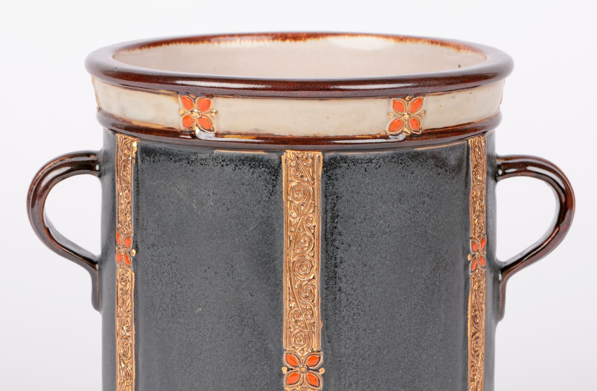 An interesting and unusual Doulton Lambeth Art Deco twin handled wine cooler designed by Maud Bowden and dating from around 1930. This large and very stylish stoneware wine cooler is of cylindrical shape standing on a wide round unglazed foot with