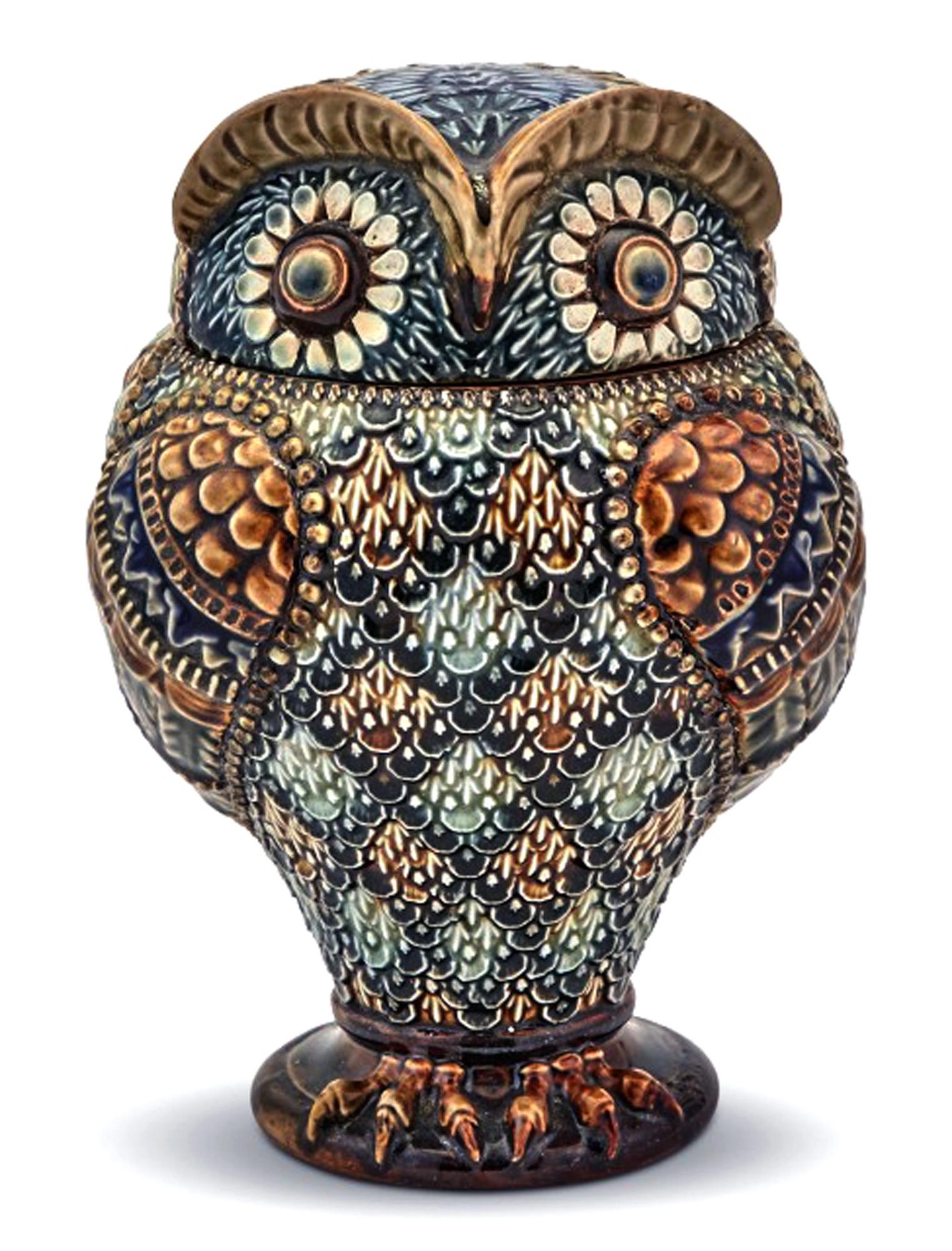 Doulton stoneware jar and cover in form of an owl,
Marked for Mark V. Marshall,
Dated 1883.

A striking tobacco jar and cover in the form of an owl with diamond pattern designs acoss the body and eyes like daisy's.

Dimensions: 7 1/2 inches