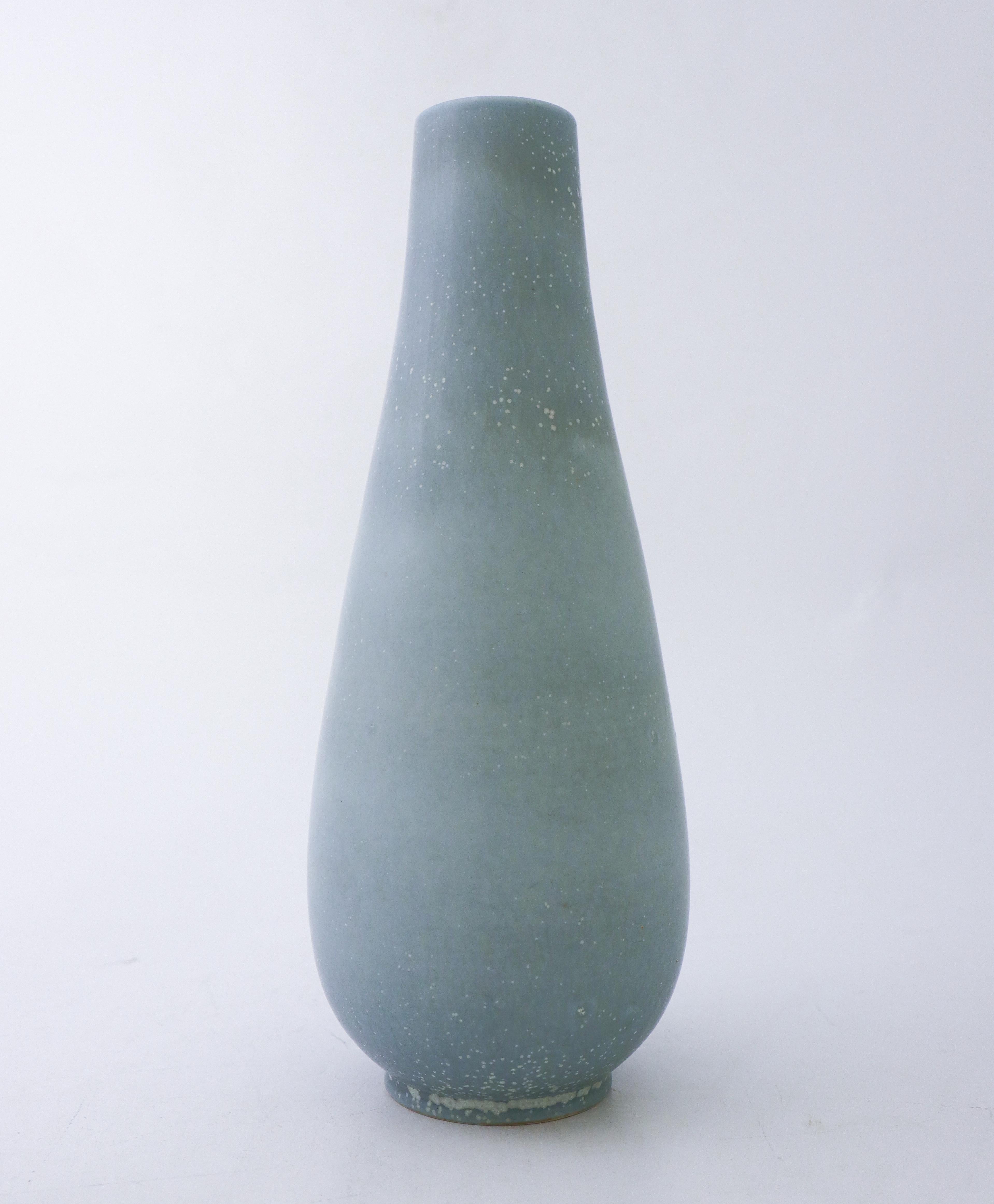 A dove blue ceramic vase designed by Gunnar Nylund at Rörstrand, it´s 28 cm (11.2) high. It´s in excellent condition except from a crack at the base from the production, therefor it is marked as 2nd quality. 

Gunnar Nylund was born in Paris 1904