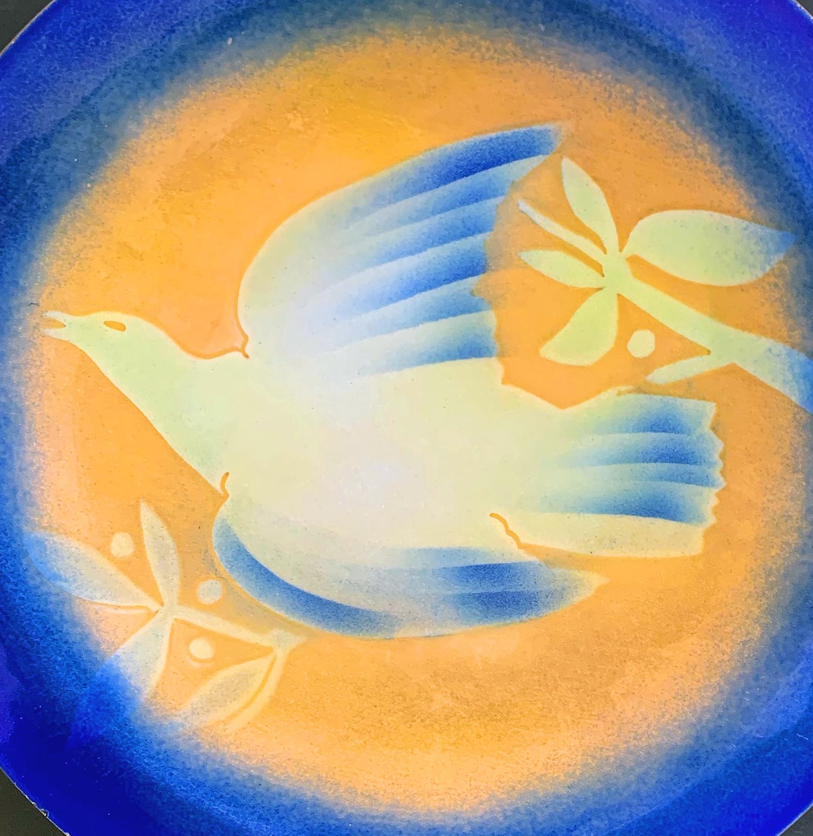 Created by one of the great masters of enamel artistry in America, this wide, shallow dish/bowl bathed in brilliant yellow and cerulean blue enamels over copper depicts a dove in flight, flanked by branches with leaves and berries. The artist was