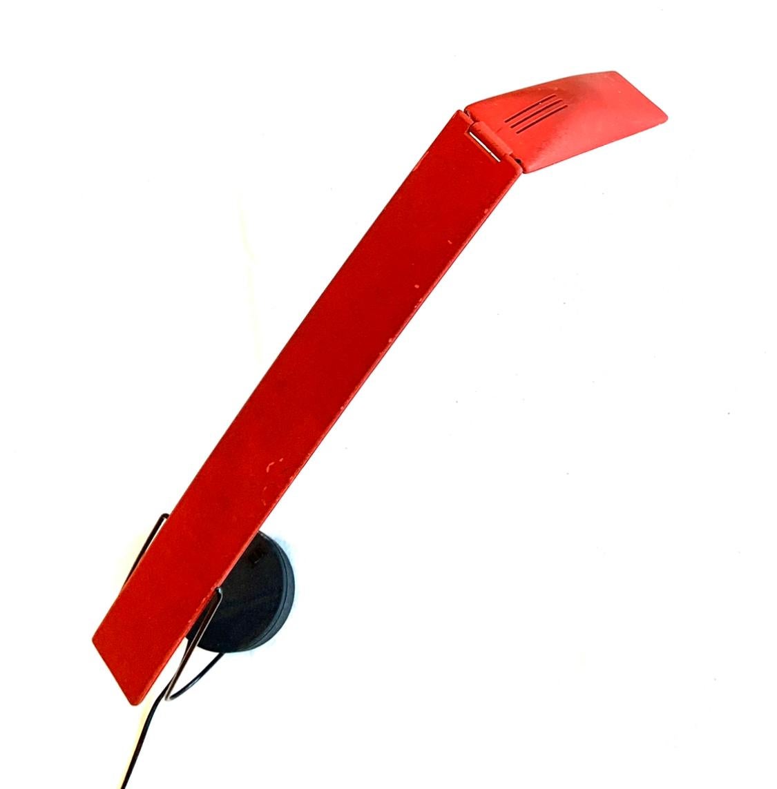 Dove lamp.
Designed by Mario Barbaglia and Marco Colombo for PAF Studio, Milan, Italy.
This iconic lamp is made from red/black plastic and metal.
Plastic structure with metal supports, height adjustable and rotates on its base.
Halogen lamp with