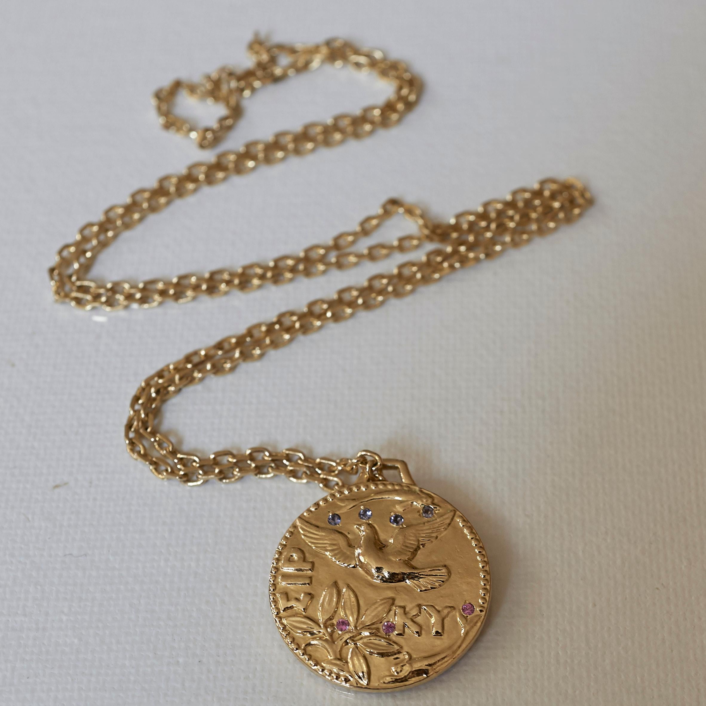 Dove Pegasus Greek Bronze Medal Medal Necklace  3 Pink Sapphires 4 Tanzanites Gold Filled Chain J Dauphin

This piece has two greek coins soldered together with a dove and the other one with a Pegasus. On the side of the dove its has 4 Tanzanites