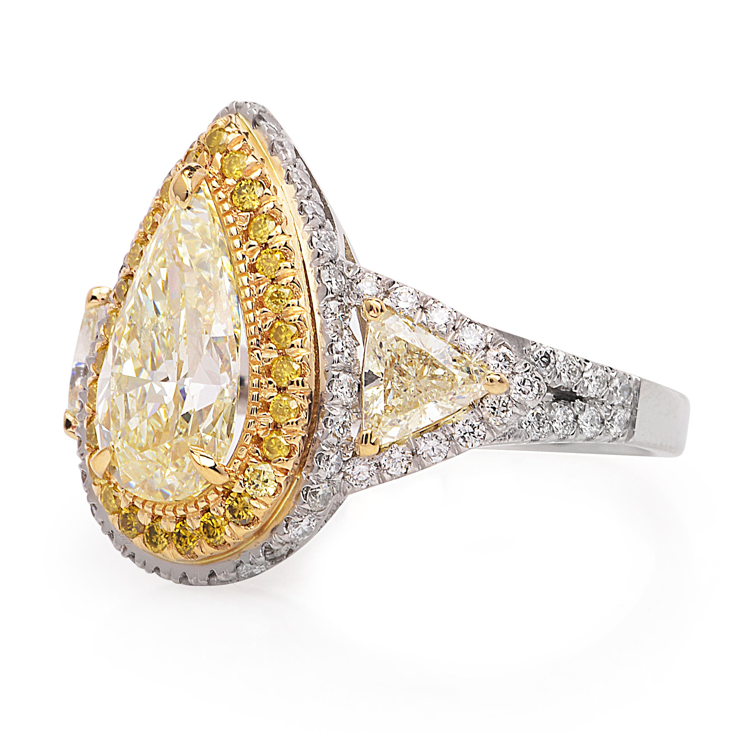This vintage inspired Engagement Ring crafted in luxurious Platinum and 18k yellow .

Adorning the center is one pear shaped 

Fancy yellow pear shaped diamond weighing approx. 2.39 carats. 

This yellow diamond is of VS2-SI1 clarity with even color