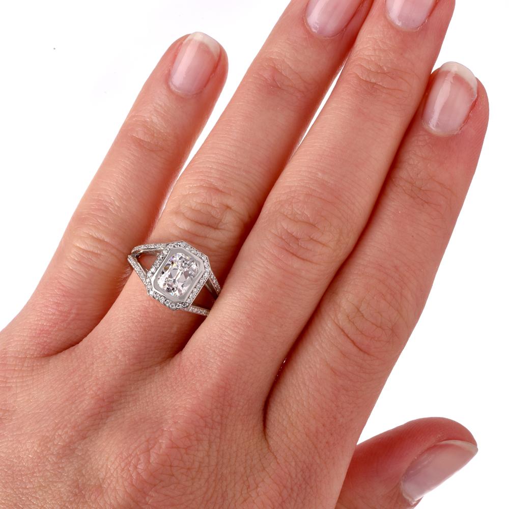 This stunning Dover Jewelry & Diamond engagement ring is crafted in solid platinum. Displaying a prominent bezel set emerald cut GIA certified diamond approx. 1.28 CT, D color, VS1 clarity. Surrounded by a halo of pave set round-cut diamonds