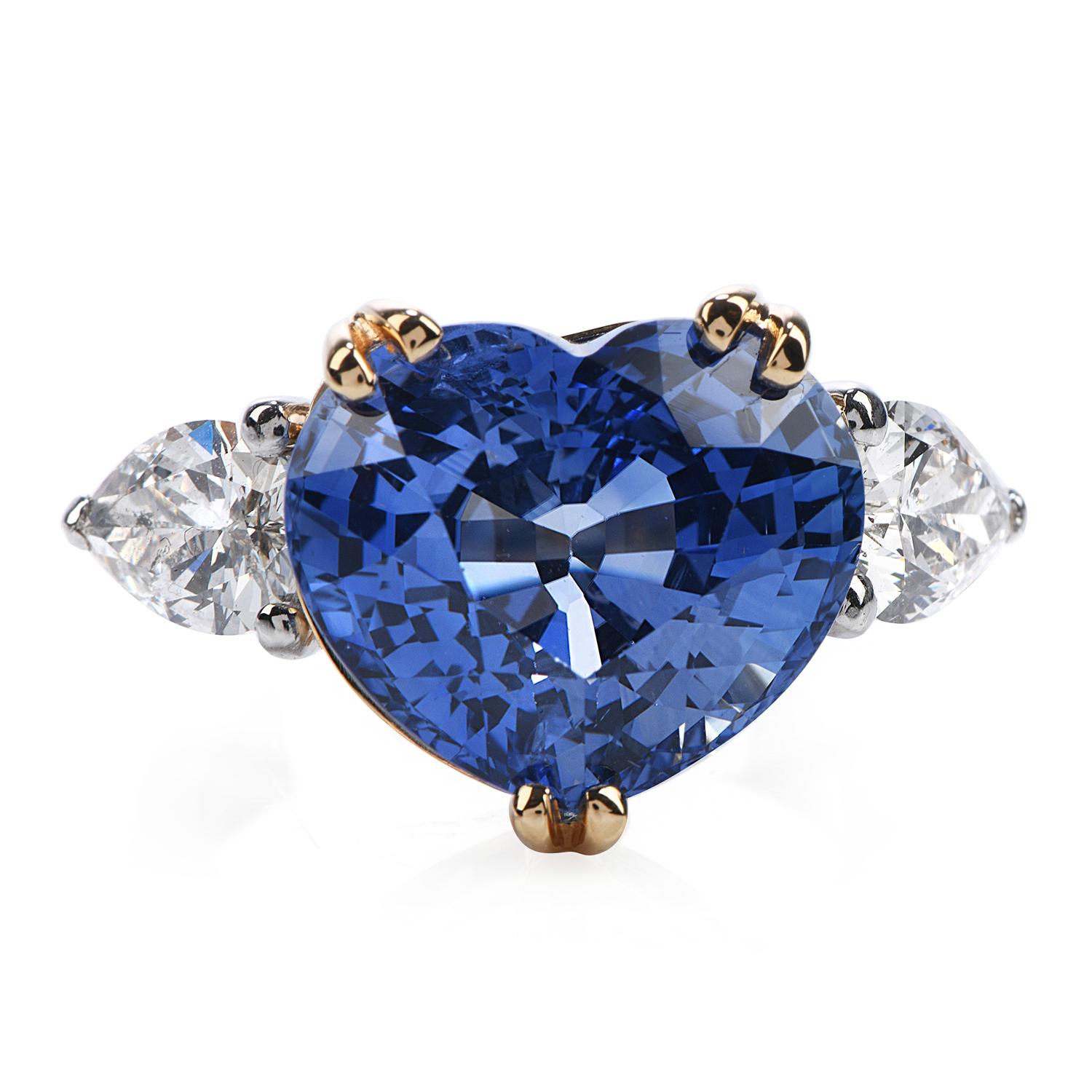 This classic three stone sapphire and diamond ring is hand crafted in solid platinum and 18k yellow gold. Exposing the center with a violet blue Natural corundom genuine blue heart shape sapphire, heated From Sri Lanka (Ceylon origin) weighing