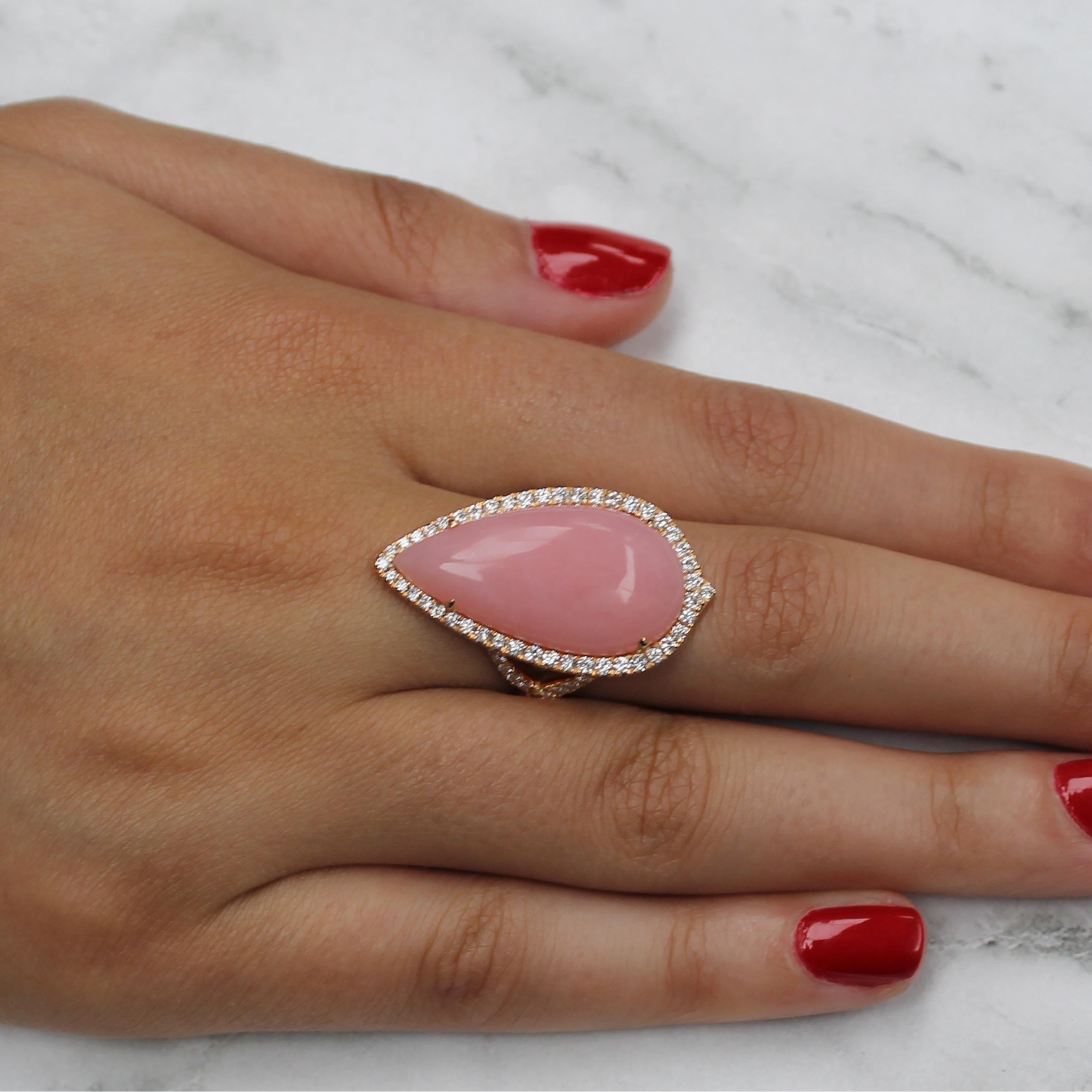 Pear-shape Cabochon-cut Pink Opal ring, with diamond halo, split diamond shank, set in 18K rose gold. A versatile ring that can be worn in either north or south direction. Finger size 6.5, adjustable upon request/quote. Pink Opal is a powerful