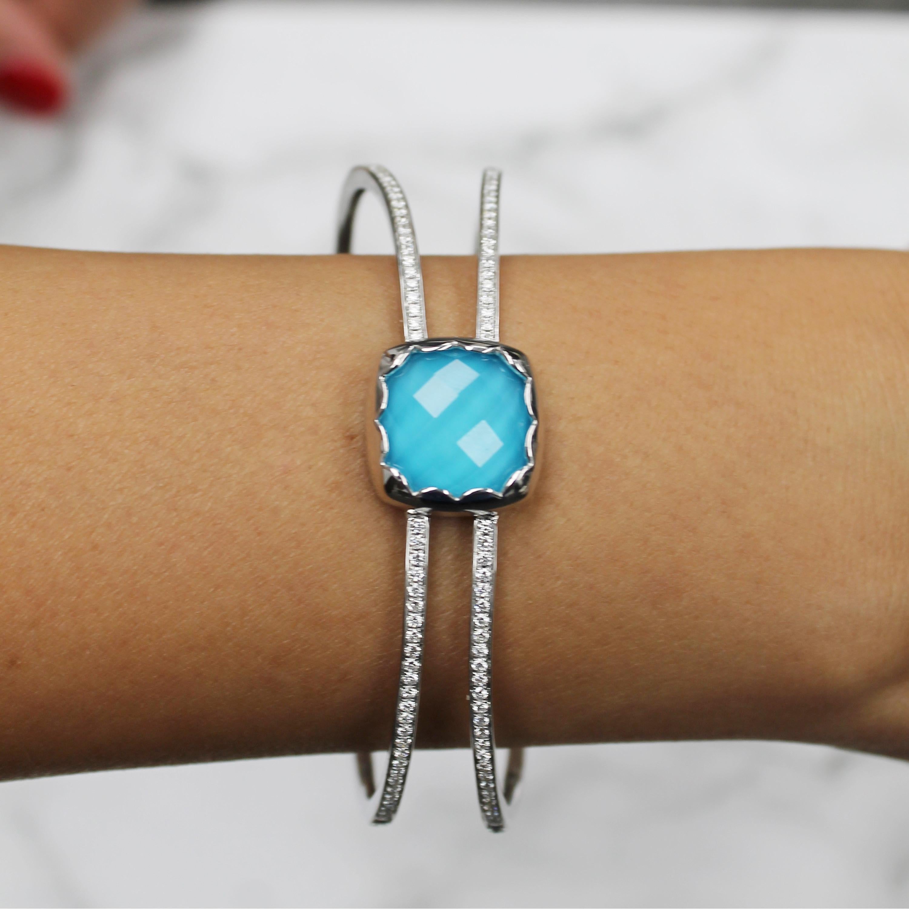 St. Barths Blue Cuff Bracelet featuring a cushion, checker-cut, White Topaz layered with Natural Arizona Turquoise, with an invisible hinge enclosure, set in 18K white gold. The St. Barths Blue collection from Doves by Doron Paloma takes you to the