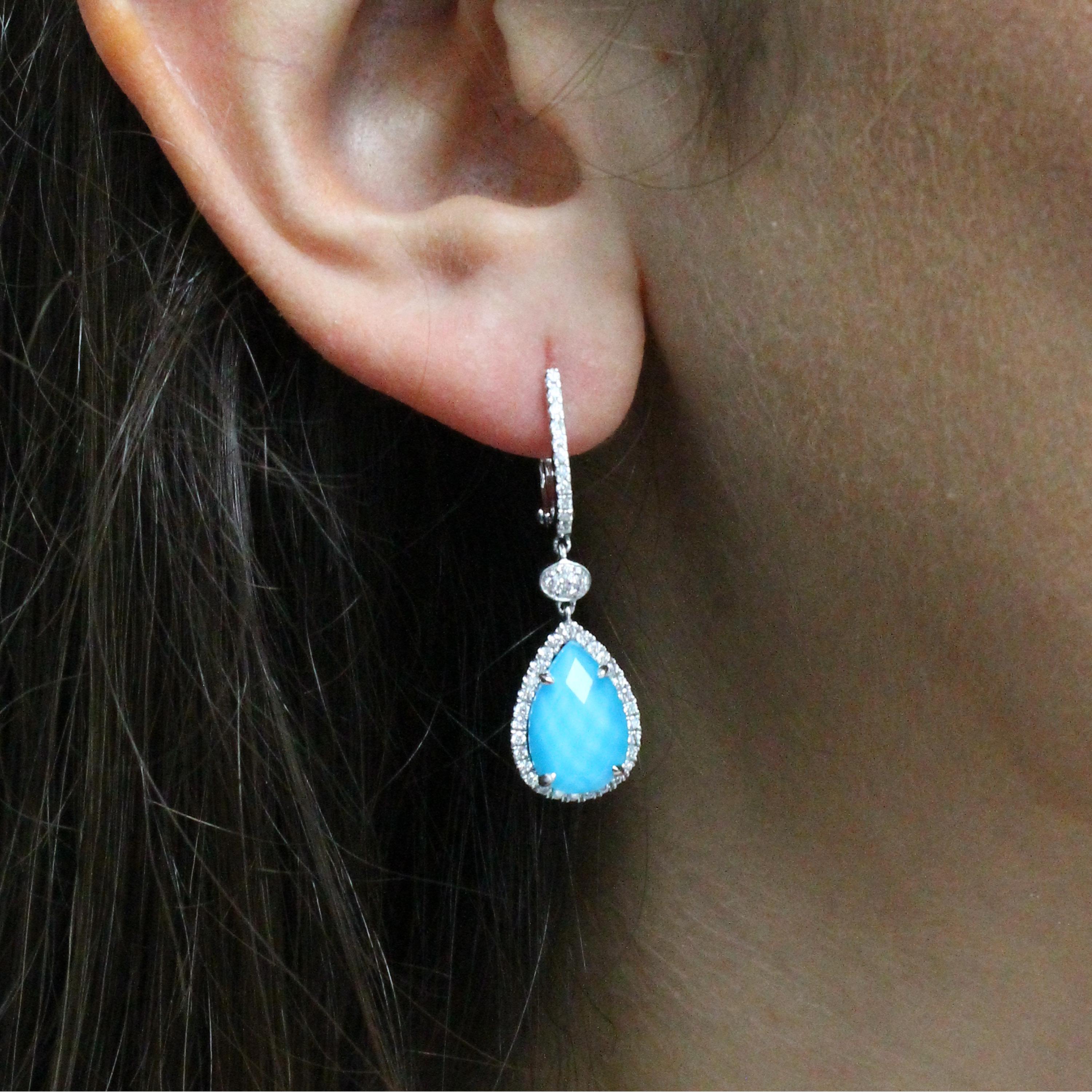 St. Barths Blue Dangle Earrings featuring checker-cut, pear shaped White Topaz layered with Natural Arizona Turquoise, surrounded by a diamond halo, set in 18K white gold. Earrings hang from diamond huggie tops, with an oval pave of diamonds in