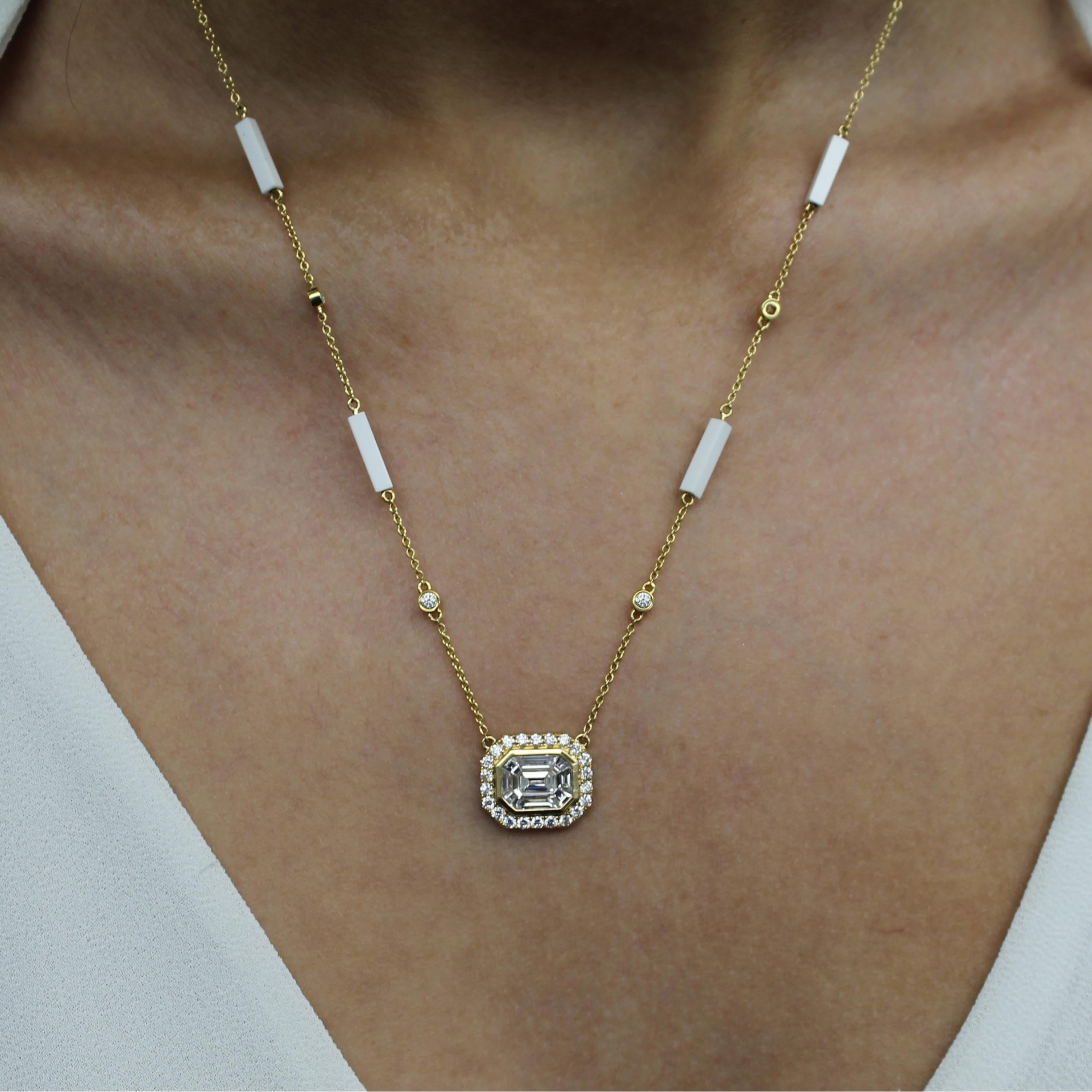 Mykonos Necklace featuring an Invisible-Set Emerald Diamond Center made up of Baguettes, framed in 18K yellow gold and Diamond Halo. 18-inch 18K Diamond and White Agate Stattion Chain, with adjuster at 16-inches. The Mykonos collection from Doves by