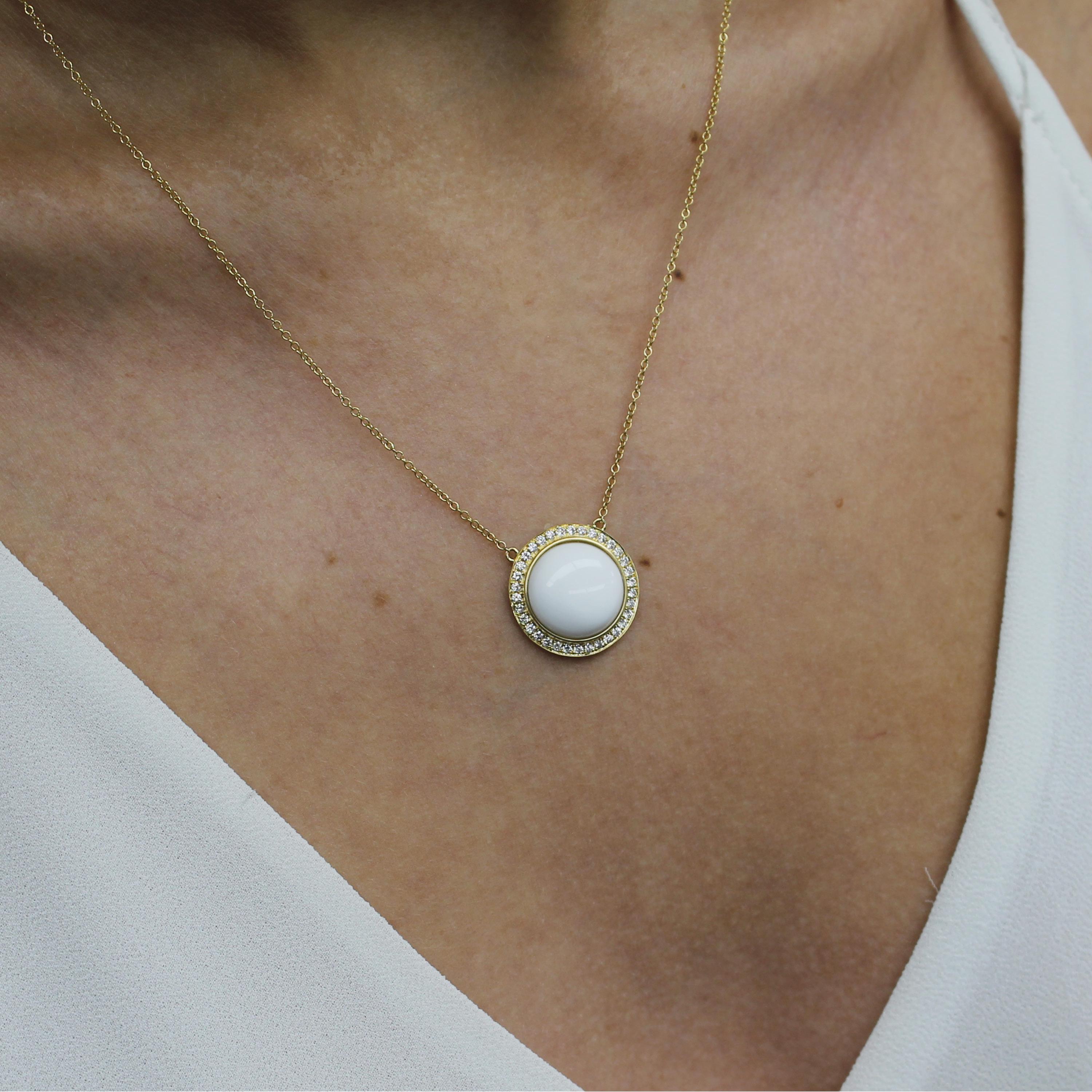 Mykonos Necklace featuring a Cabochon-Cut Round White Agate with Diamond Halo, framed in 18K yellow gold. 18-inch 18K Yellow Gold Chain, with adjuster at 16-inches. The Mykonos collection from Doves by Doron Paloma pays homage to the serene blue