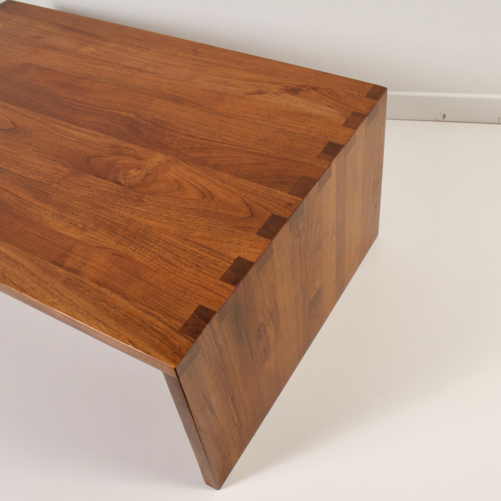 Modern craftsman coffee table with dramatic oversized dovetailed joints. Solid walnut construction with a side section for magazines, laptops or remotes.