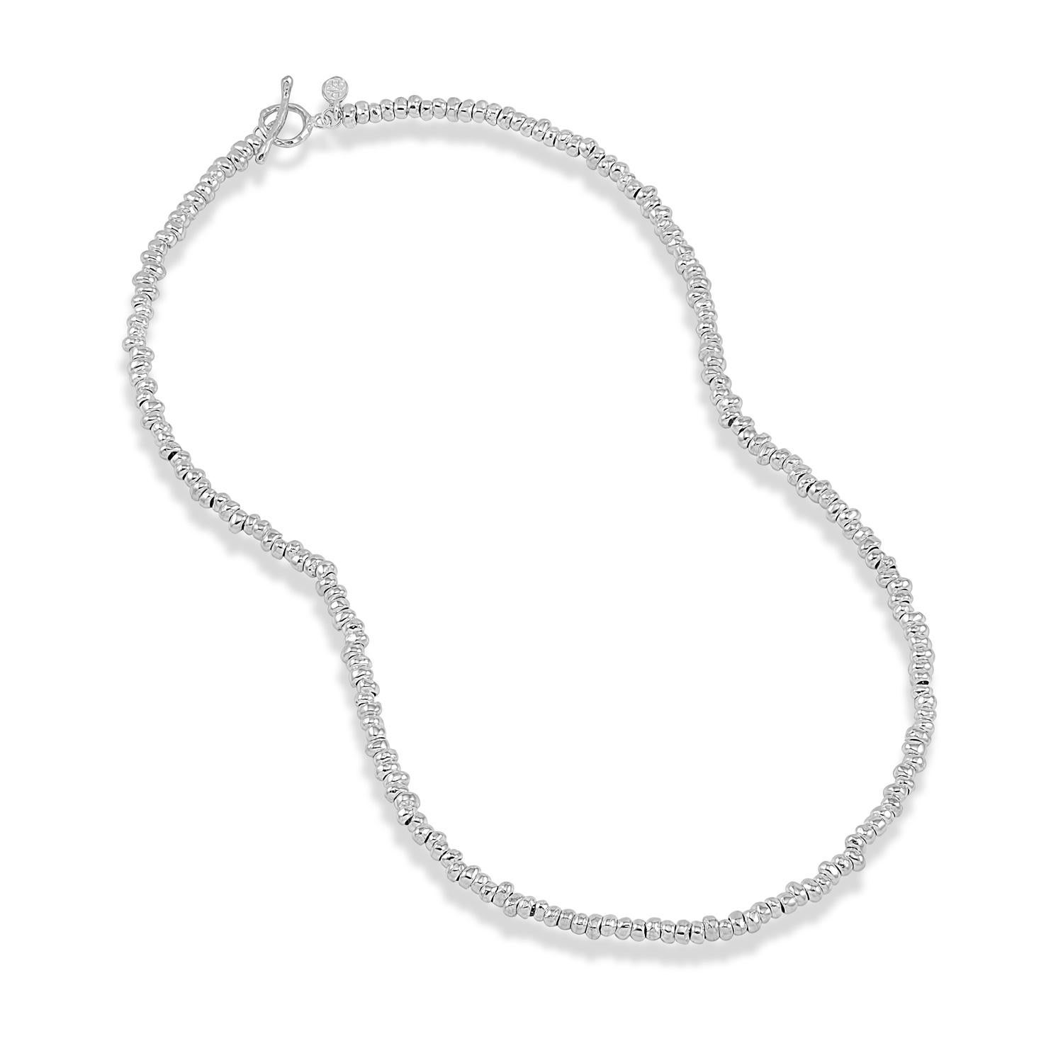 An iconic Dower & Hall design, this sterling silver Nomad necklace is made of small pebble-shaped nuggets threaded onto chain. The necklace is finished with our signature hammered loop and t-bar clasp. A timeless classic.
Taking inspiration from