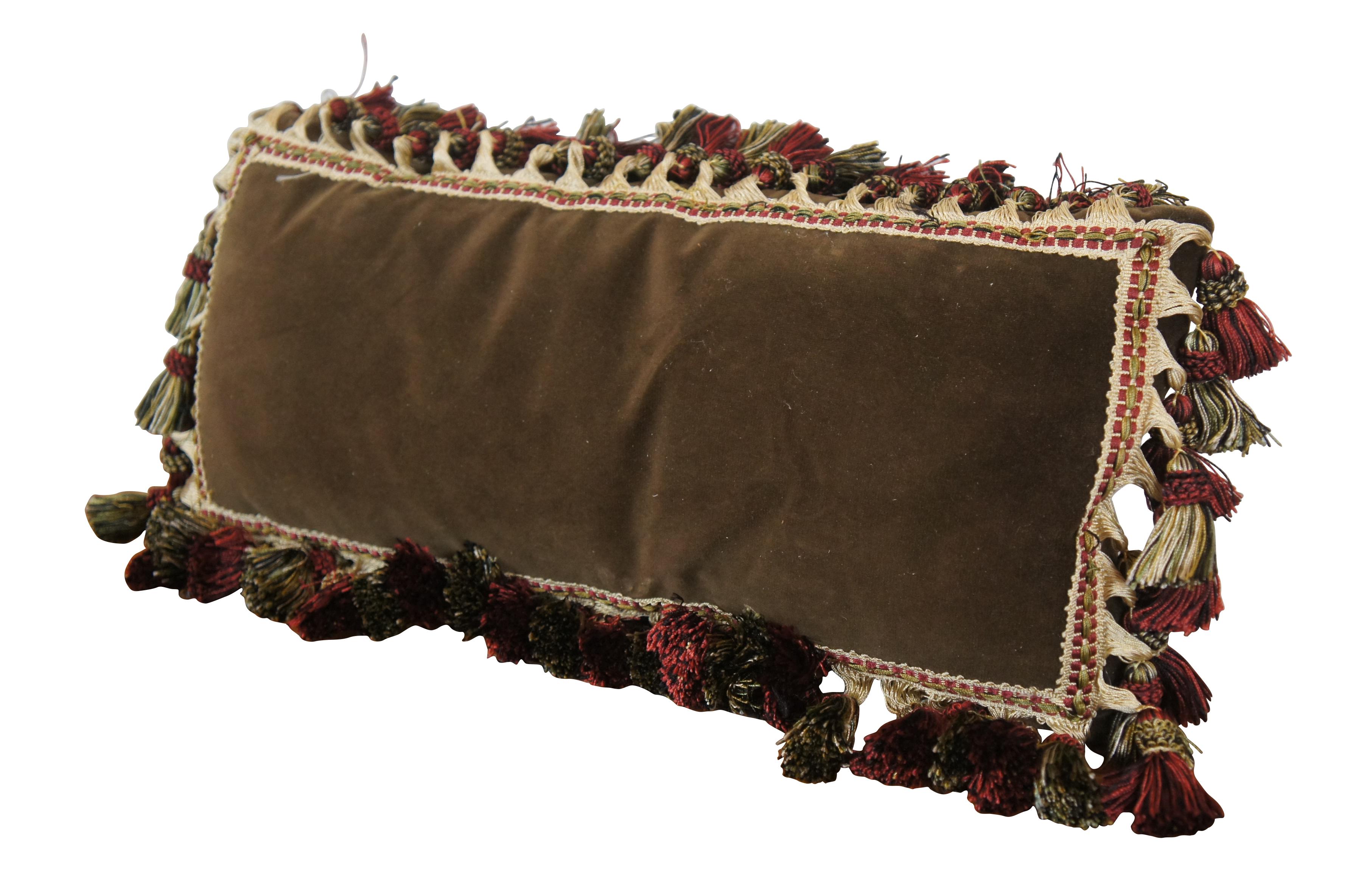 20th century down filled dark brown velour / velvet lumbar throw pillow with cream, red, and green braided and tassel trim. Sewn closure.

Dimensions:
9