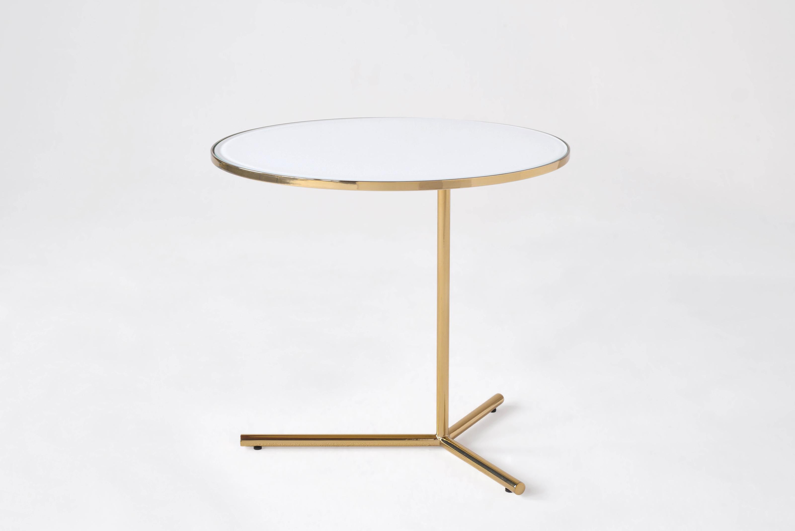 Downtown Medium Table by Phase Design
Dimensions: Ø 50,8 x H 45,7 cm. 
Materials: Spandrel glass, steel and polished brass.

Solid steel base available in flat or gloss black and white powder coat, polished chrome, burnt copper, or smoked brass