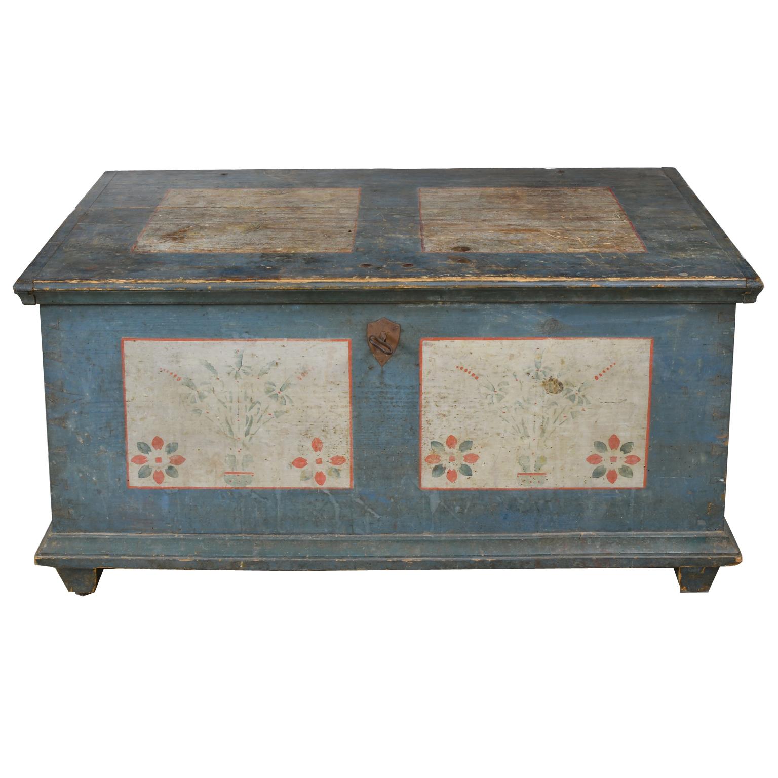 A very beautiful wedding chest with the original painted finish with blue background and square white panels on the hinged top, front and sides decorated with floral design in blue and orange tones. Chest opens to a small lidded compartment and