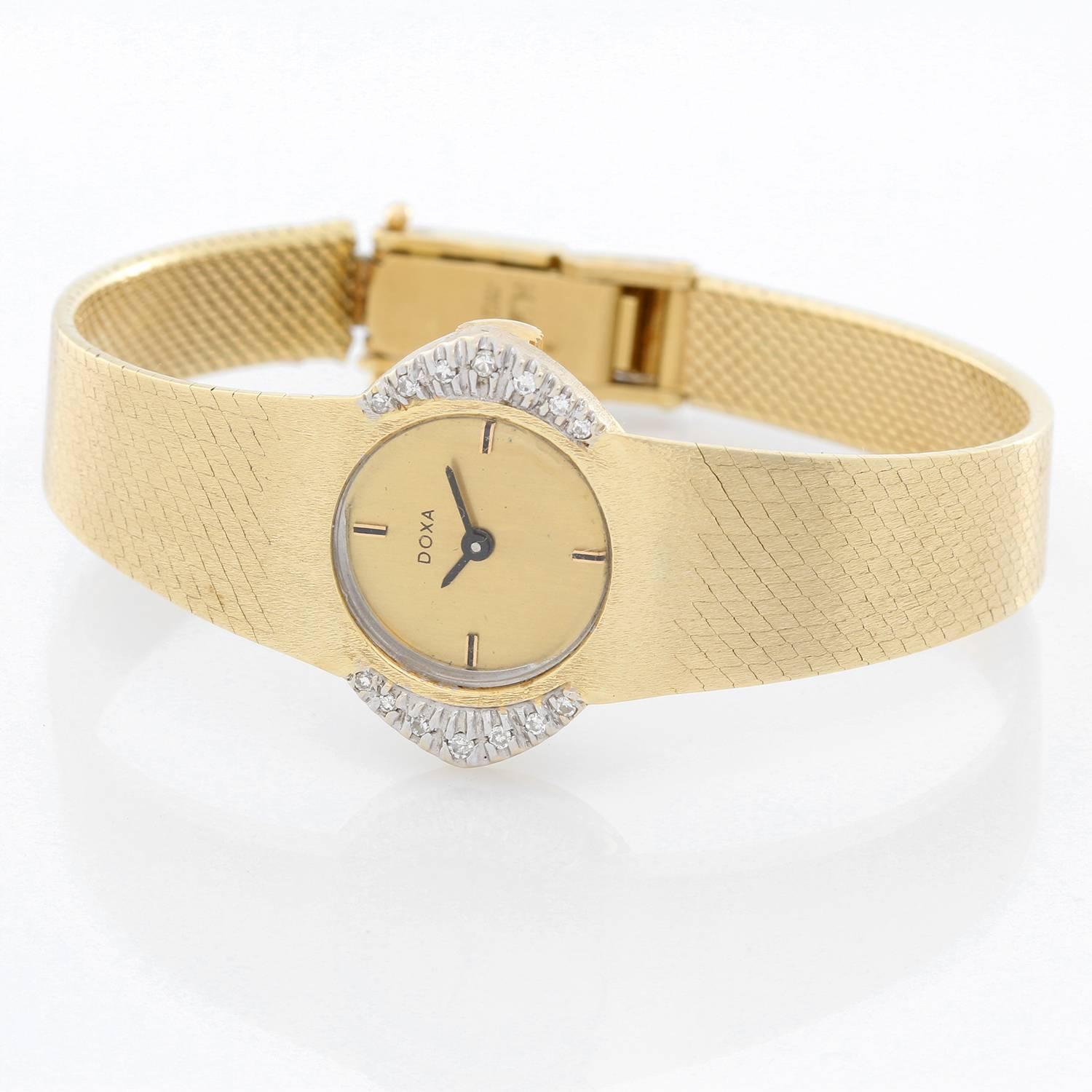 Doxa Classique 14K Yellow Gold Watch  - Manual winding . 14K Yellow Gold ( 23 mm ) with diamonds on the sides . Champagne dial with hour stick markers at 12, 3, 6, 9 o'clock . 14K Yellow Gold hammered mesh bracelet . Pre-owned with custom box. Wrist