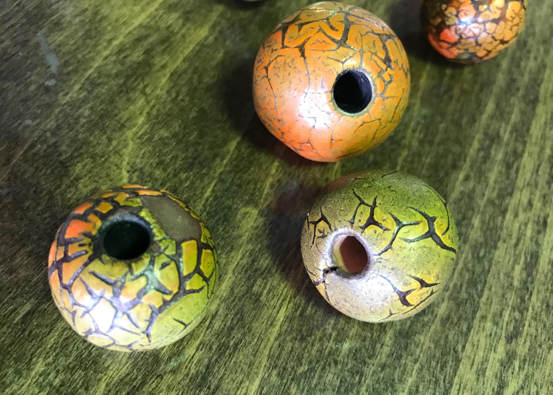 A beautifully glazed set of 5 multicolored ceramic beads by famed midcentury American artist/potter Doyle Lane. Lane was a glaze specialist much like Glen Lukens and Otto Natzler. His colorful glazes would melt, bubble and crack over his pieces