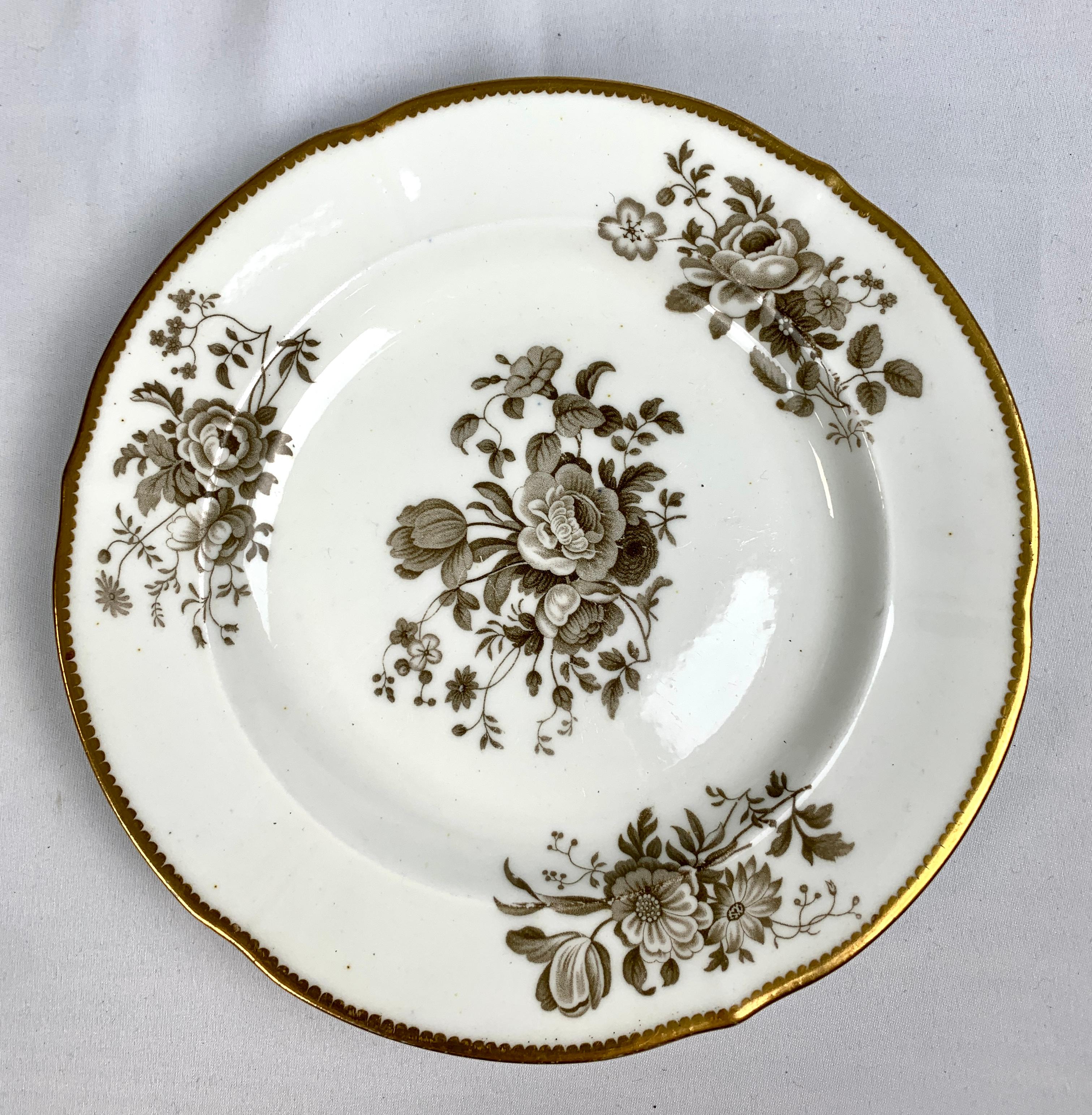 This set of a dozen Minton dessert plates was made in England circa 1835.
The beautiful grisaille decoration shows a center bouquet of lovely roses and morning glory and along the border, three bouquets of chrysanthemums, daisies, and