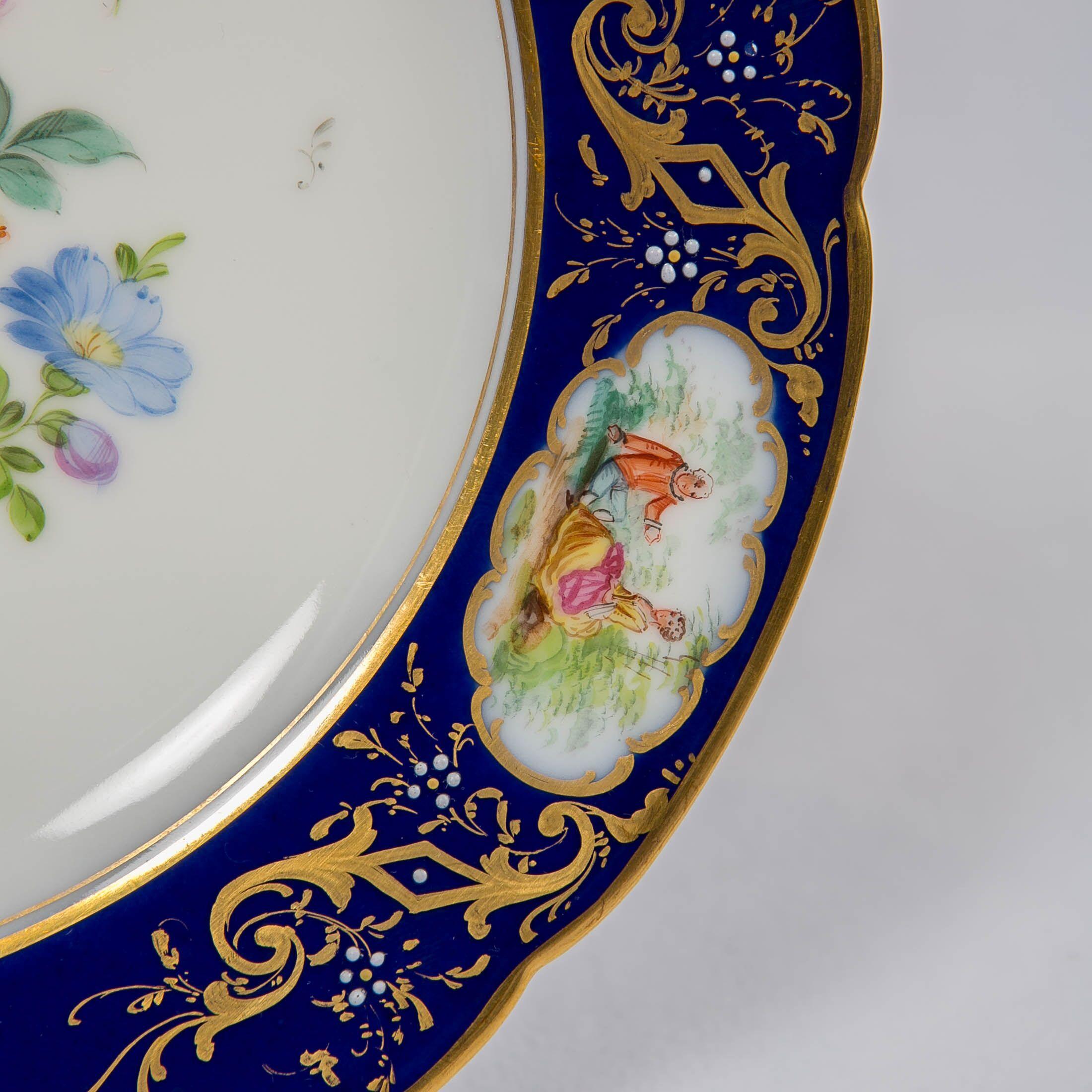 Gilt Dozen Dresden China Dinner Dishes with Flowers and Deep Blue Borders