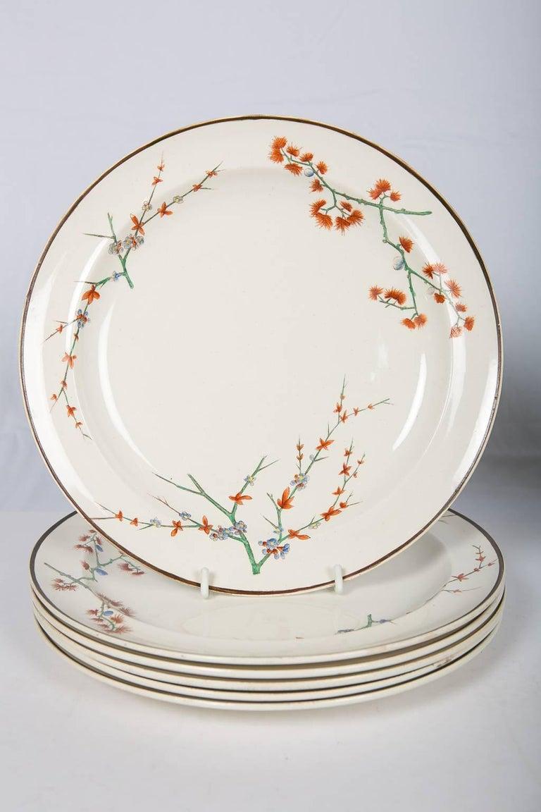 We are pleased to offer this set of a dozen Wedgwood creamware dinner plates with a thistle design.
These English creamware dinner plates date to the late 19th century, circa 1880. 
The dishes are decorated with flowering thistle boughs. Western
