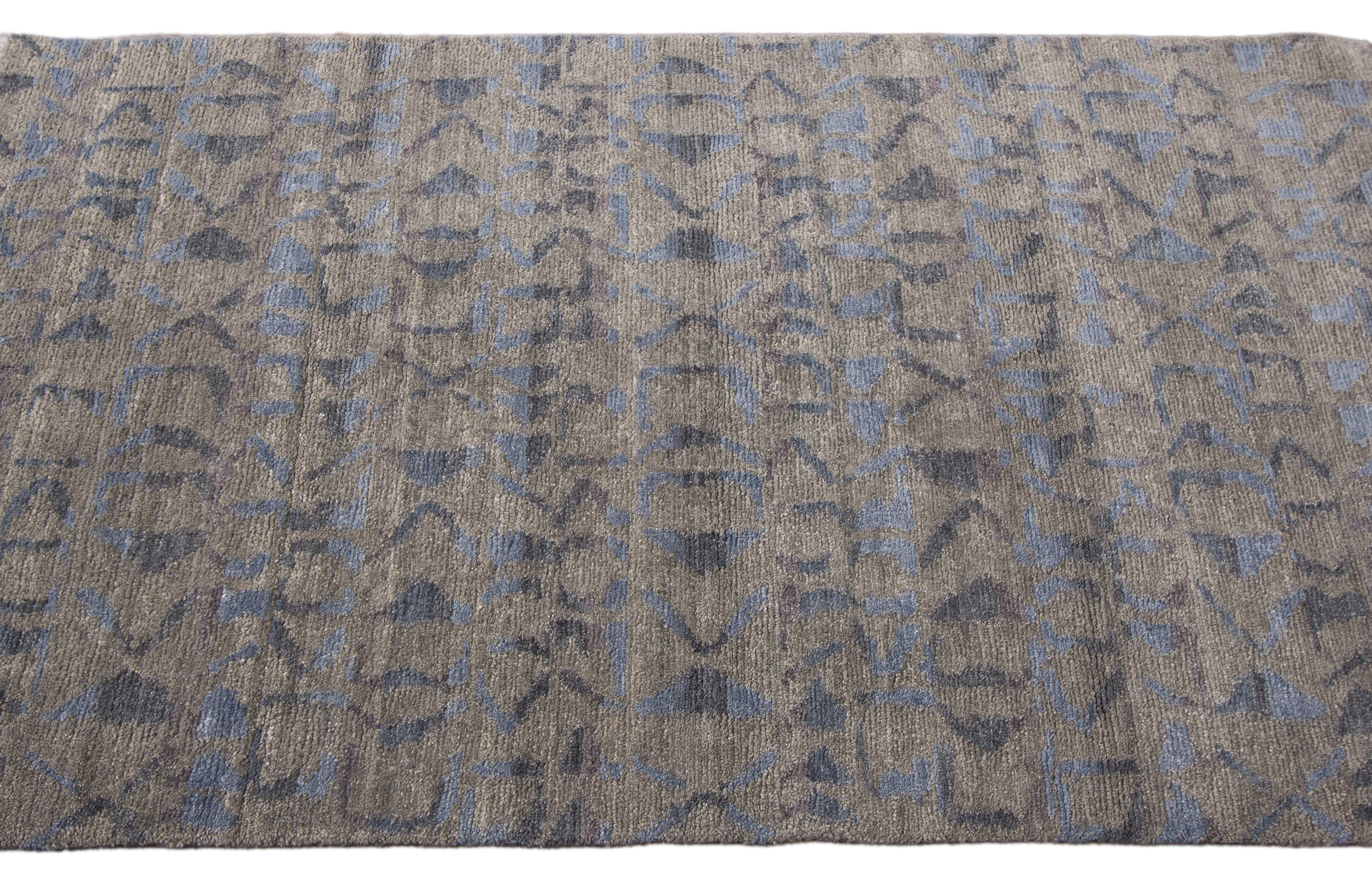 Hand-knotted rug with an all-over design on a blue field. Measures: 9' x 12'.