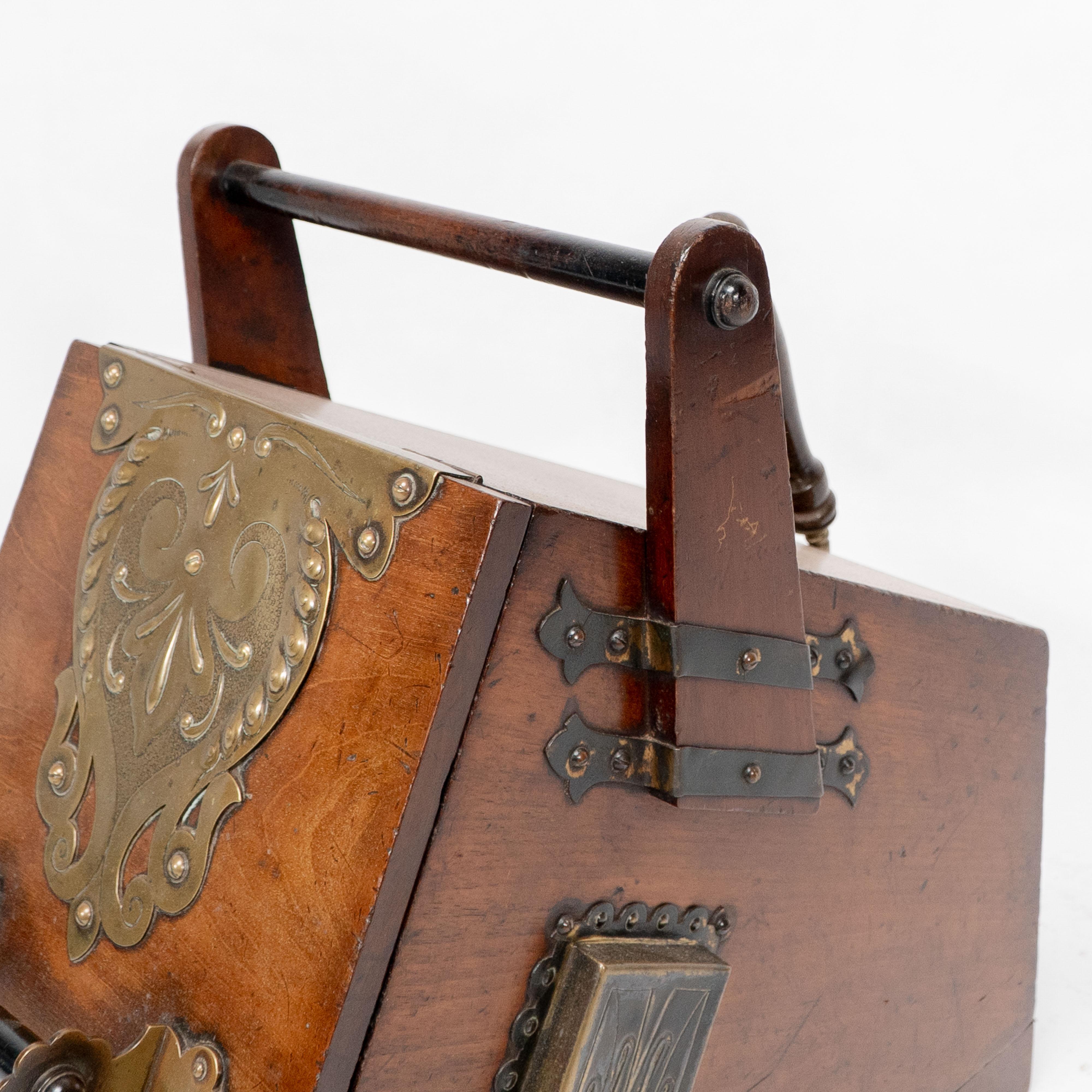 Dr C Dresser. An Aesthetic Movement walnut coal box with stylized brass panels For Sale 9