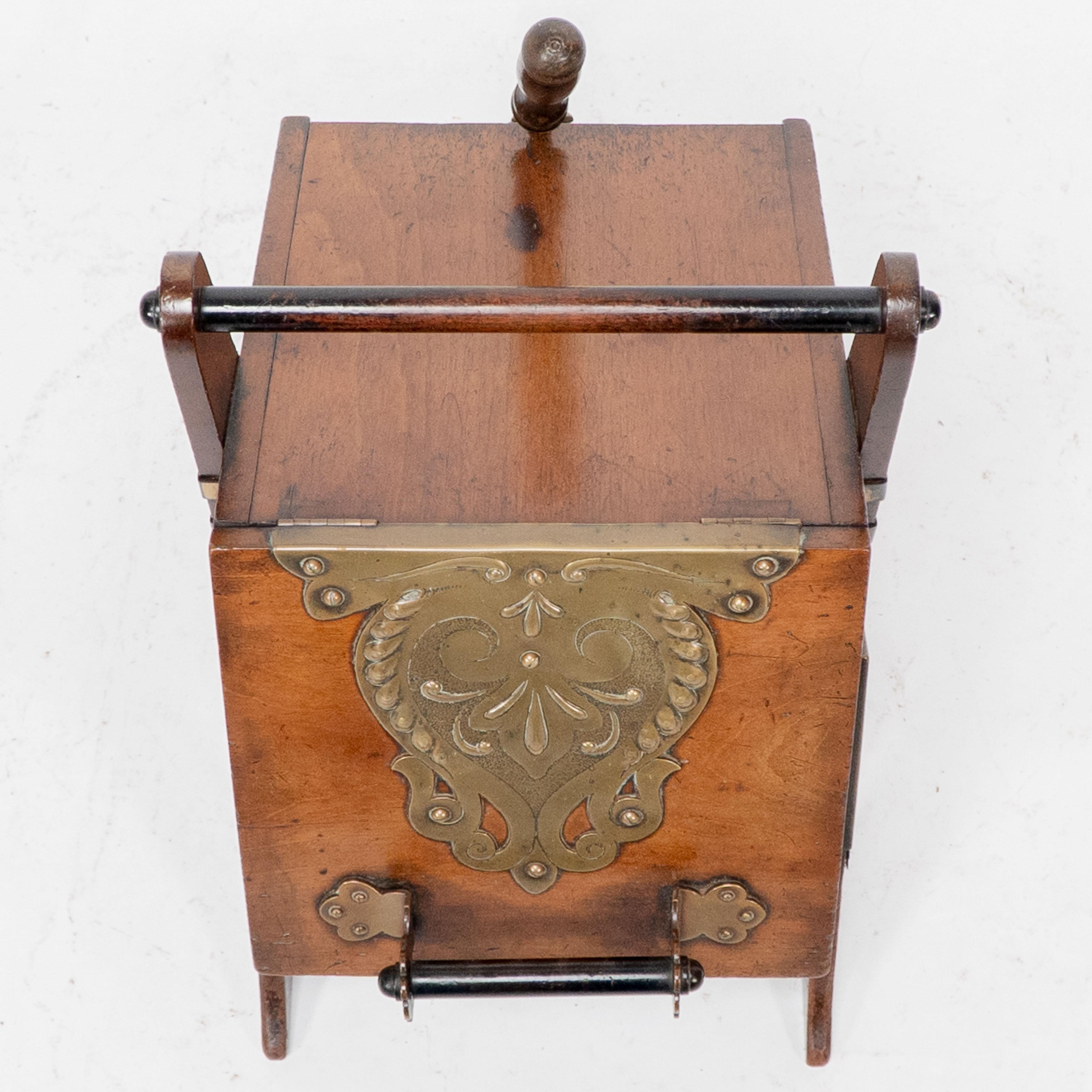 Dr C Dresser. An Aesthetic Movement walnut coal box with stylized brass panels For Sale 2