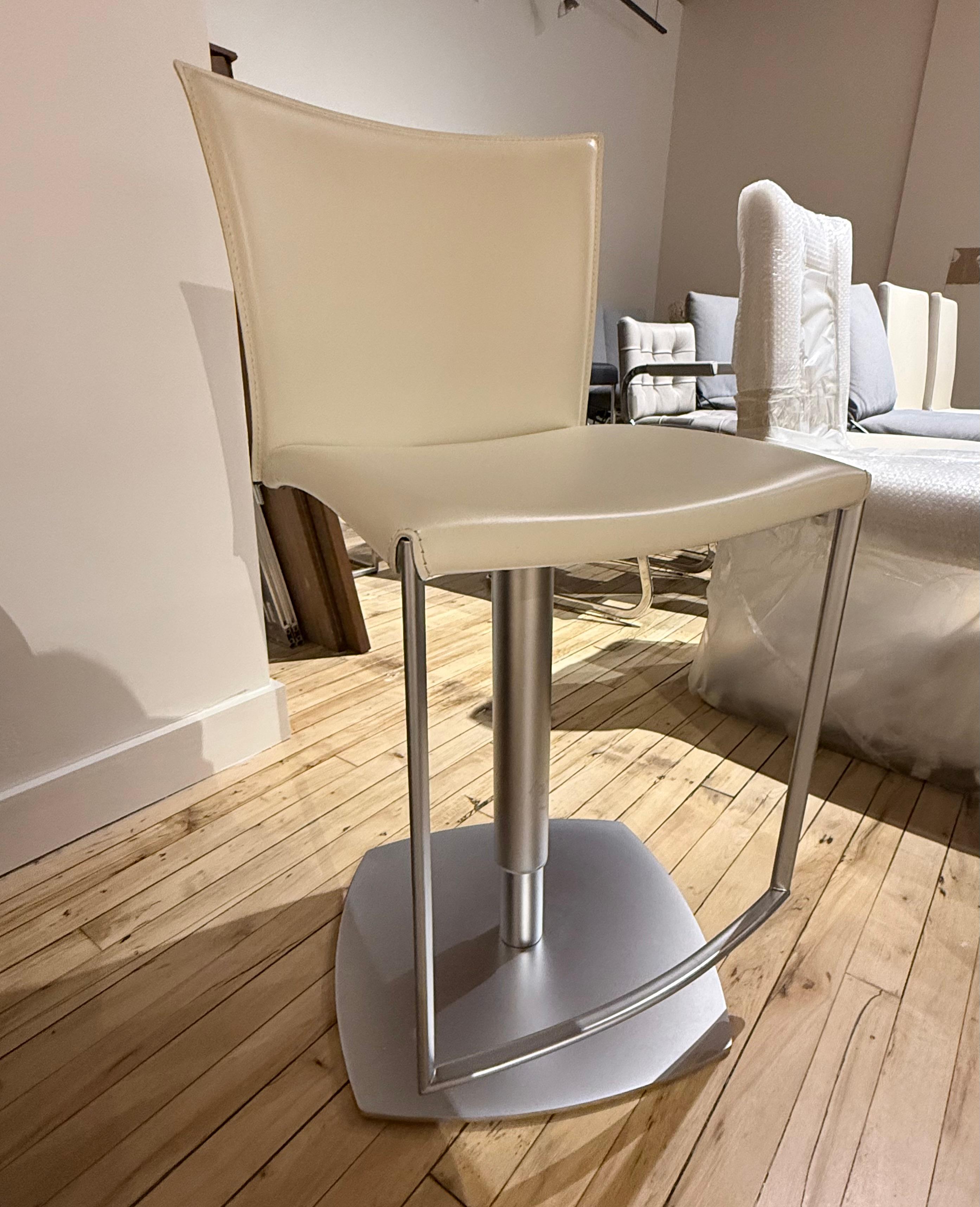 A core leather bar stool. The steel bracing in the lower part has a polished chrome finish.