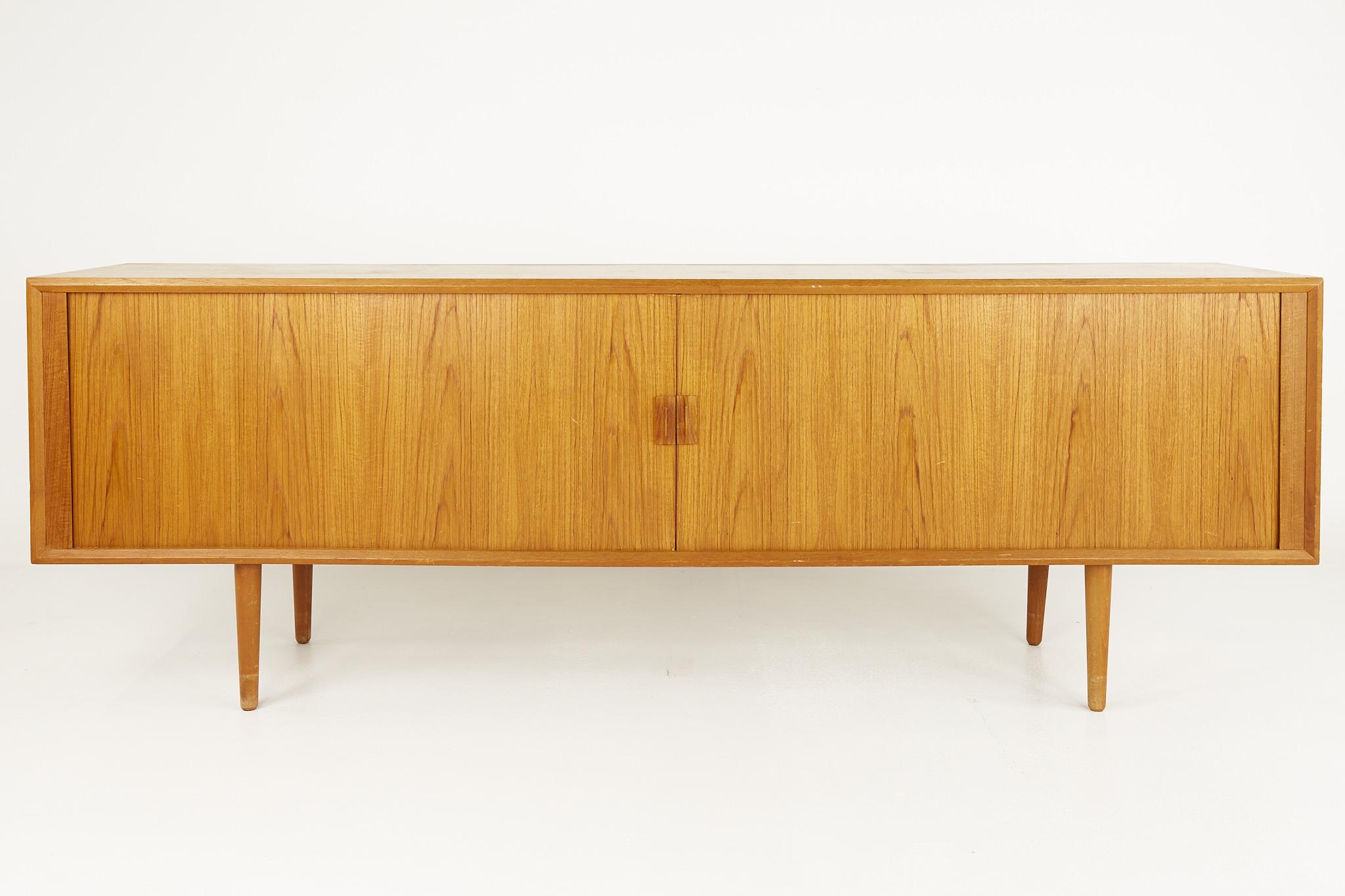 Svend Aage Larsen mid century teak tambour door long sideboard buffet credenza

This credenza measures: 90.5 wide x 19 deep x 31.25 inches high

?All pieces of furniture can be had in what we call restored vintage condition. That means the piece