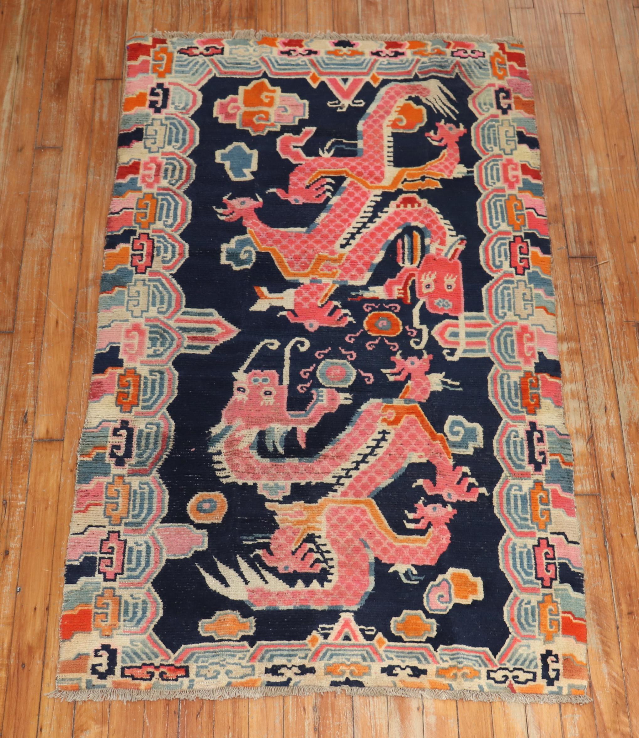 A mid-20th century Chinese rug with 2 large dragons floating on a navy blue ground.

Measures: 3'1' x 5'1