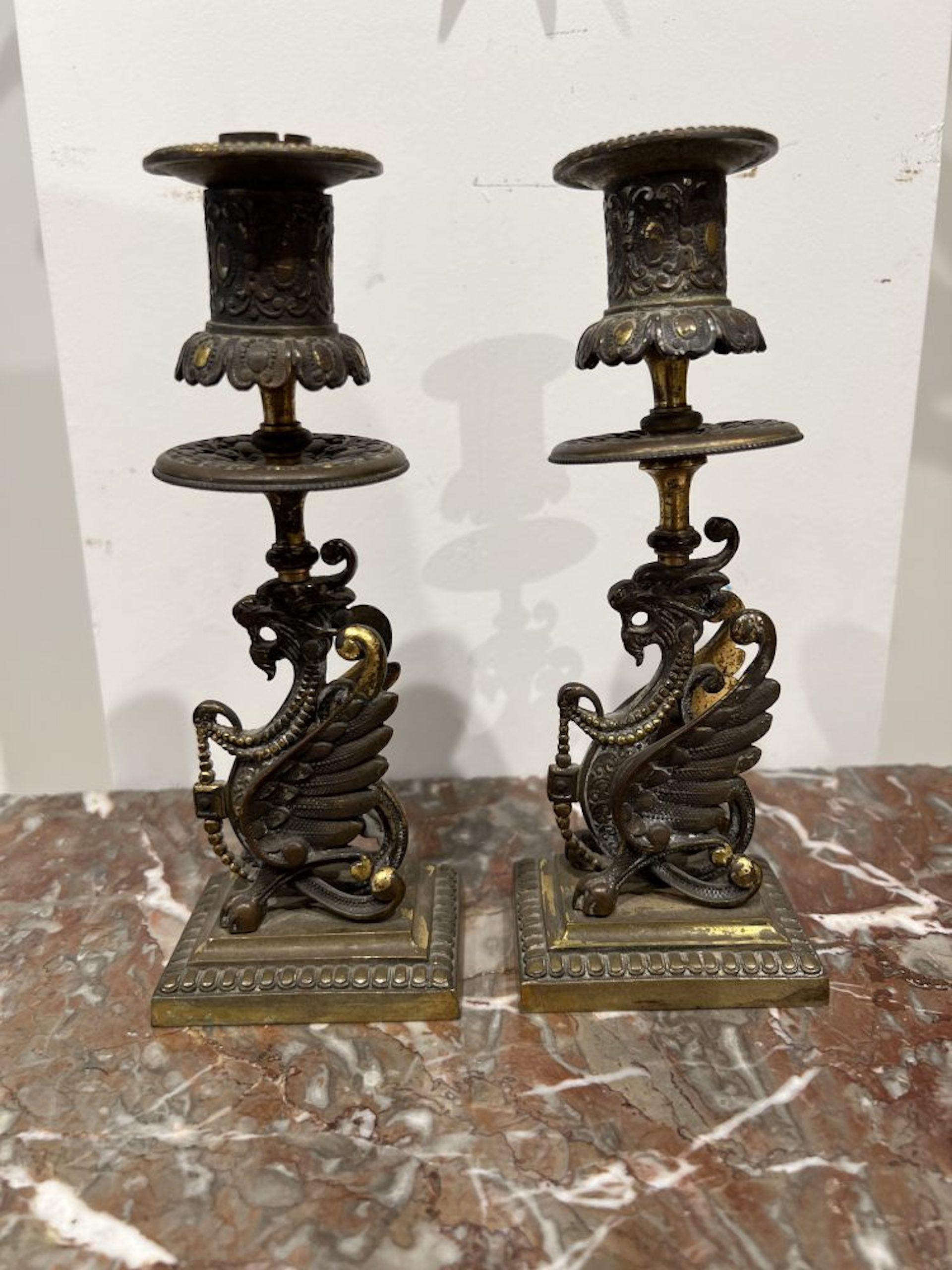 Exotic dragons embellish this pair of single candleholders.
