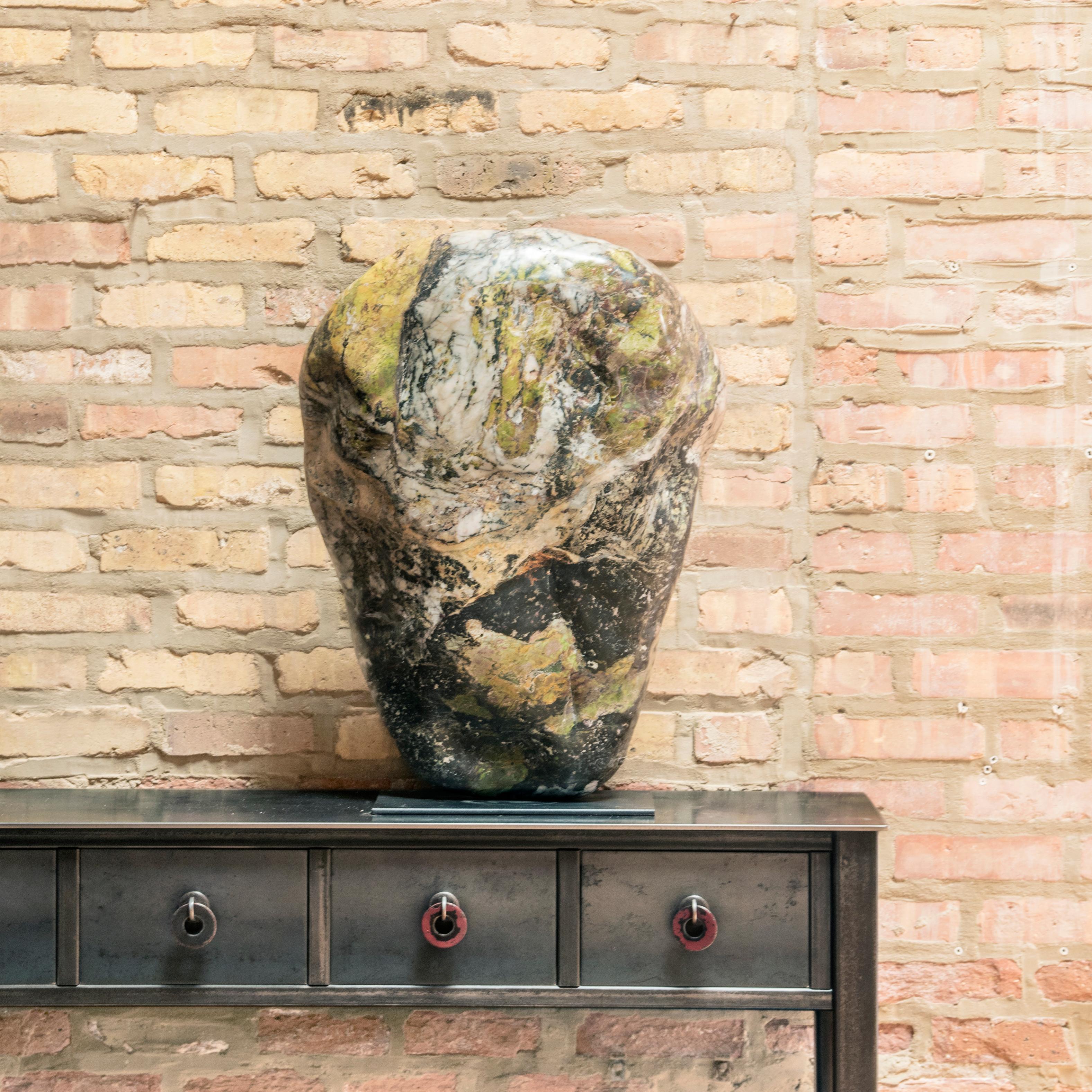 Unearthed in Jiangsu province, this stone has been polished to reveal the full array of its soft colors and intriguing patterns. Prized by collectors for centuries, colorful stones such as this were sought after by Chinese scholars who plumbed their