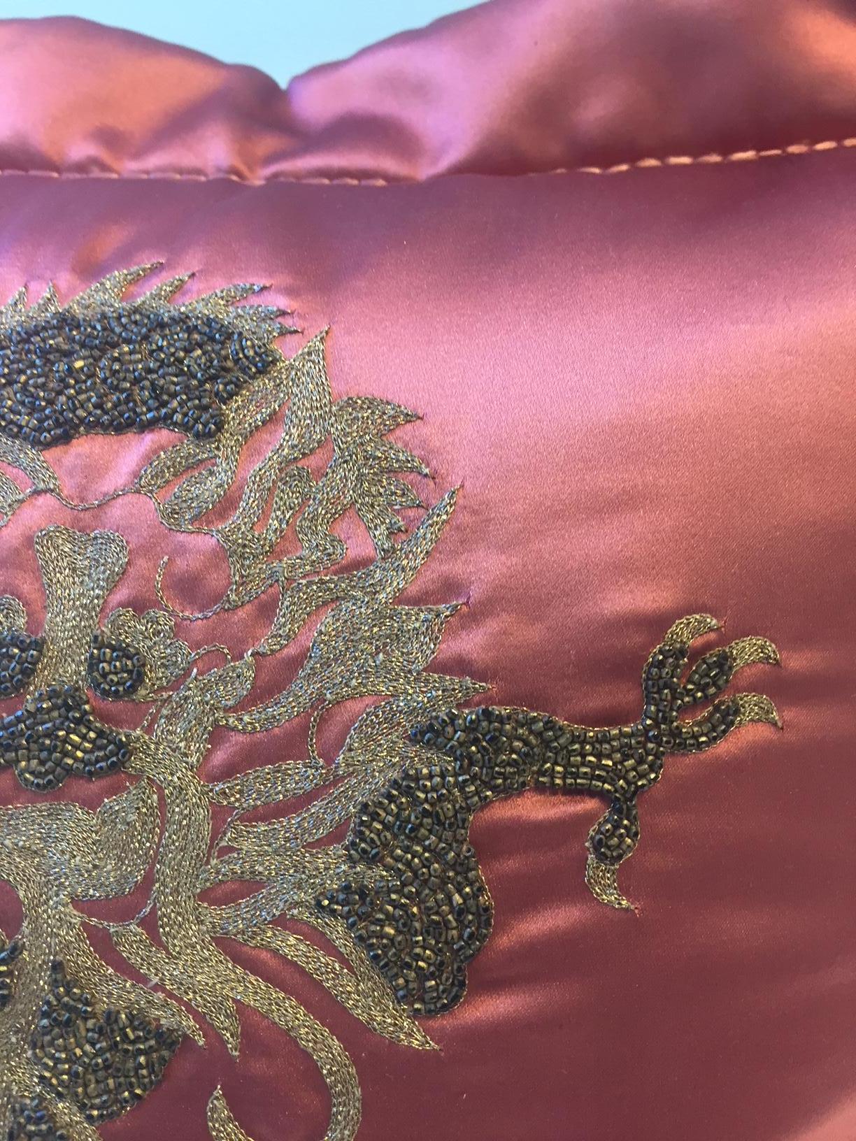 Cushion silk satin col. strawberry with dragon design hand embroidery with gold thread in different shades and with hand beading in antic gold, the cushion cover has as finish an oxford trim with hand saddle stitch, size 49 x 49cm, cushion cover