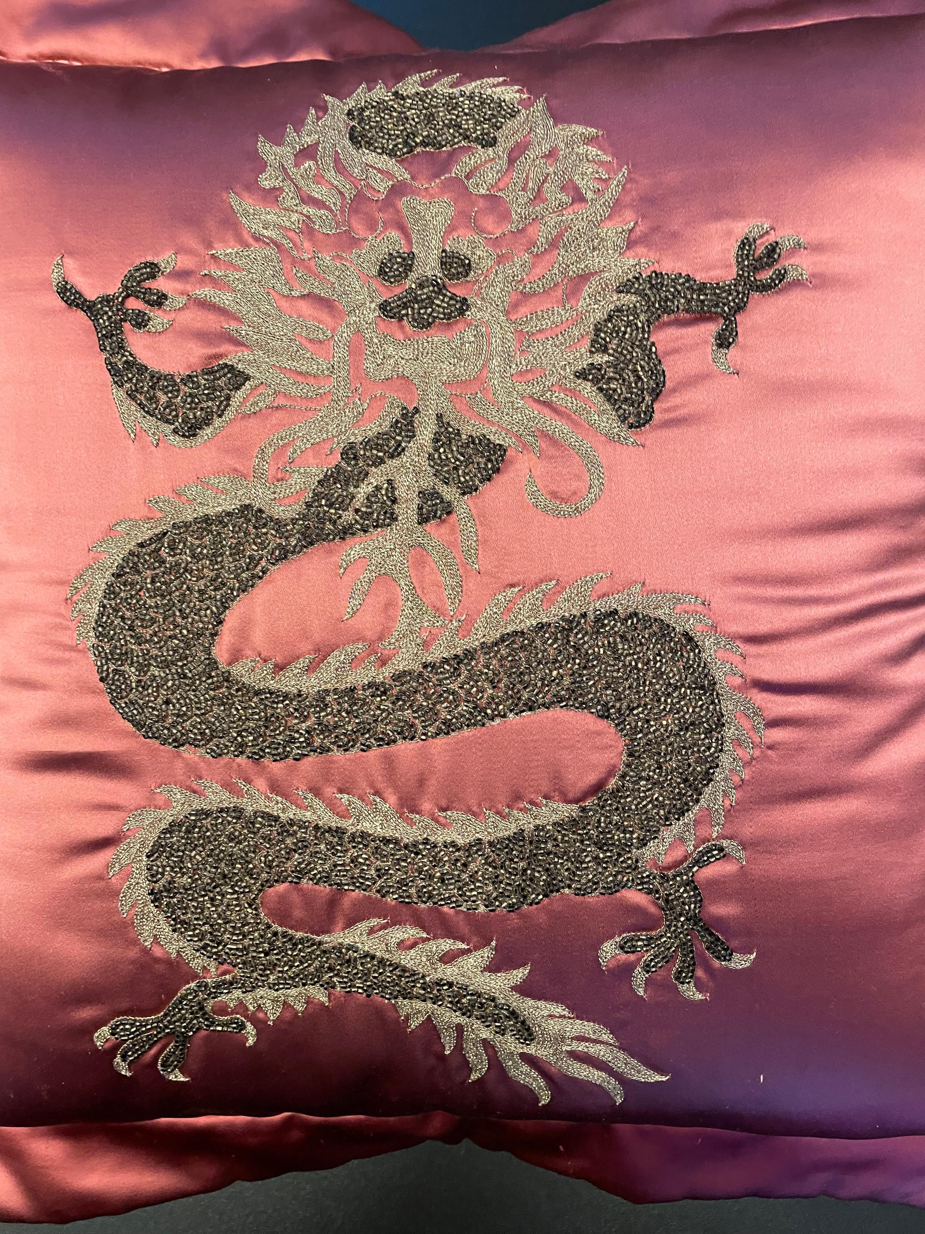 The cushion is made out of silk satin from Italy in col. strawberry red with a Dragon design: Hand embroidery worked with silver thread in a warm shade and with beading in antik silver ( dark silver )- the cushion cover has as finish an oxford trim