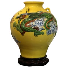 Dragon in Flight through Clouds on Large Yellow Jar