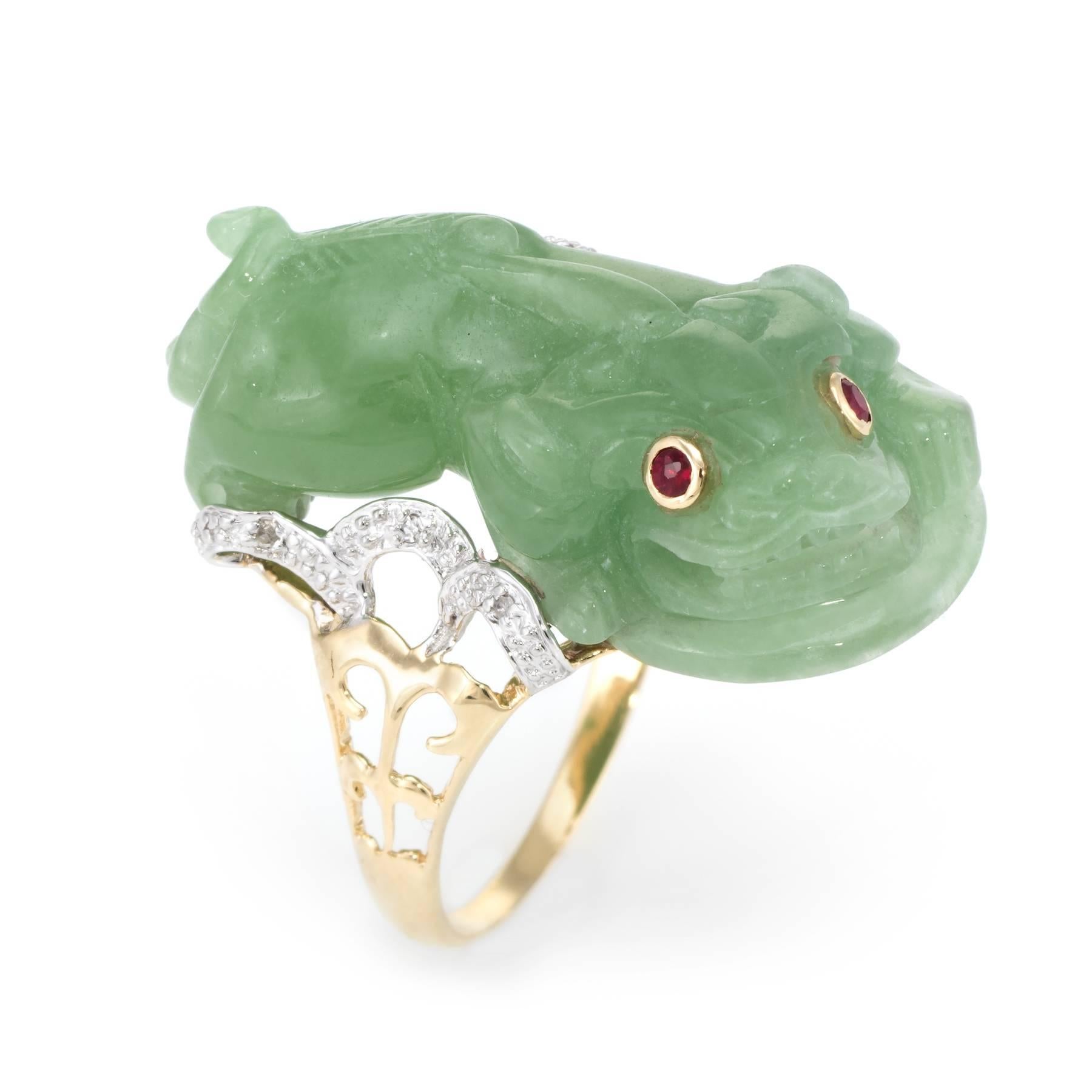 Finely detailed vintage cocktail ring, crafted in 14 karat yellow gold. 

A dragon koi fish is carved in jade, set with ruby eyes (estimated at 0.02 carats each). The jade measures 31mm x 14mm. The jade is in excellent condition and free of cracks